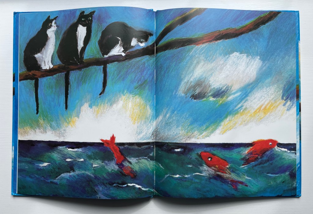 An illustrated page from the wordless picture book 'Three Cats' featuring three curious cats on a branch overlooking vibrant, swirling blue waves with three red fish swimming below.