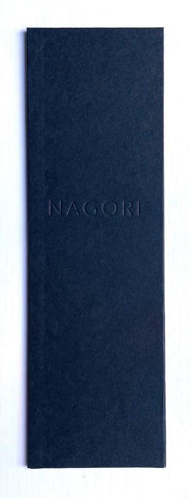 A sleek black folder with the embossed word 'NAGORI' on the front.