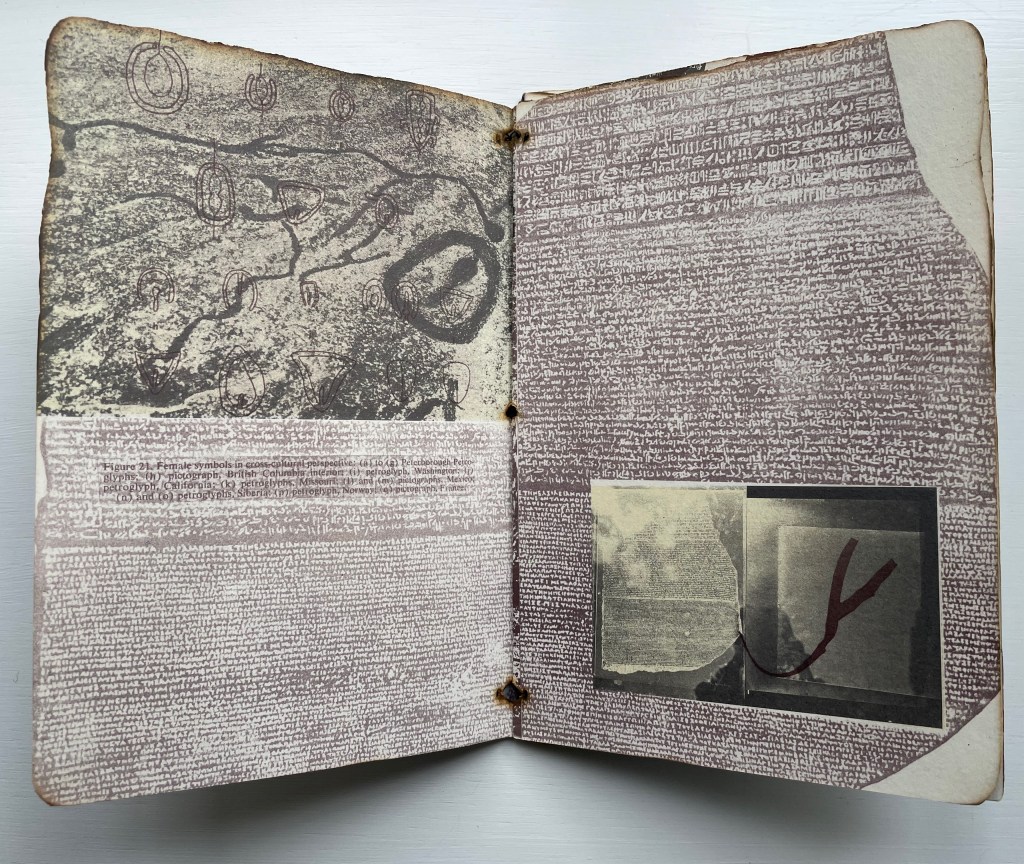 An open book displayed on a white surface, featuring pages with a mix of textured illustrations, script, and an inset photograph. The left page includes abstract symbols and lines, while the right page contains dense text with a partially visible image.