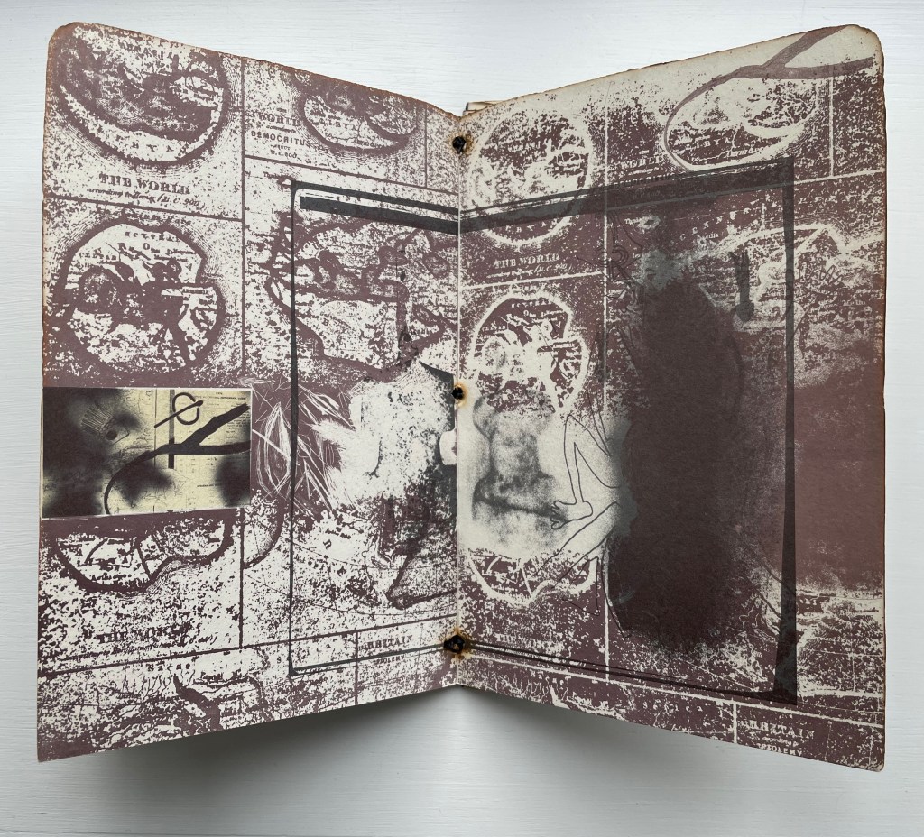 An open notebook with abstract designs and faded images, featuring a combination of earthy tones and textures.