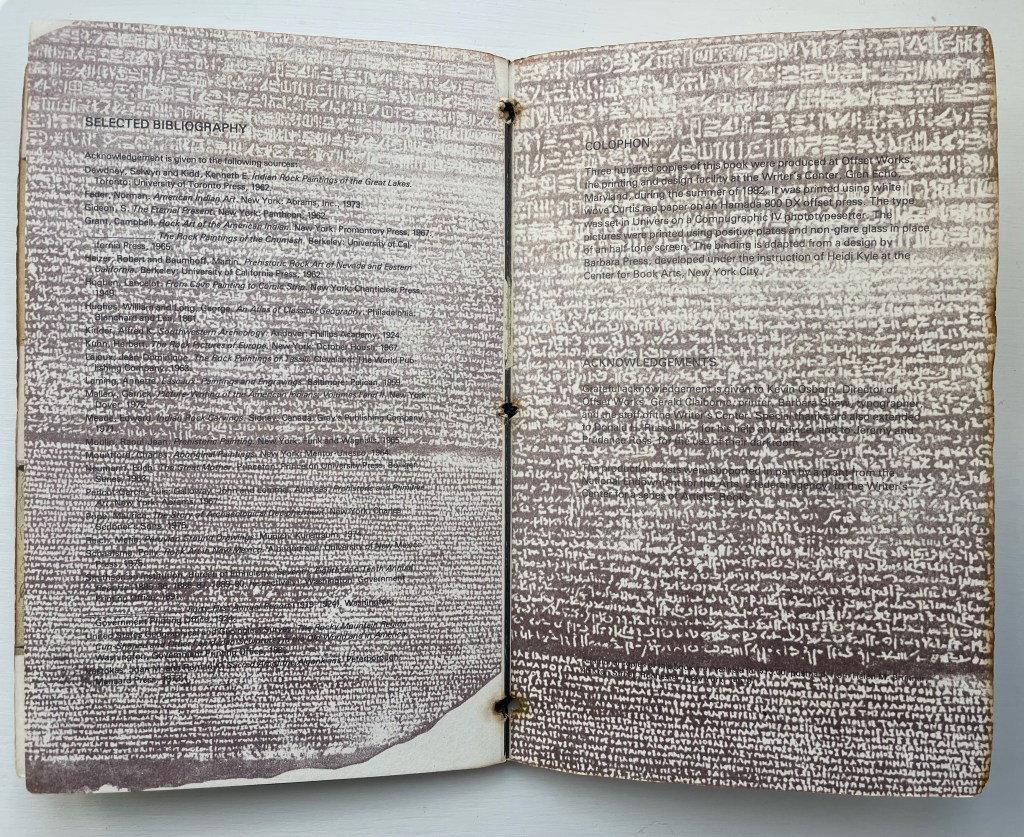 Open book displaying two pages filled with text in a script, featuring a selected bibliography and acknowledgments. The background is a textured purple with white markings.