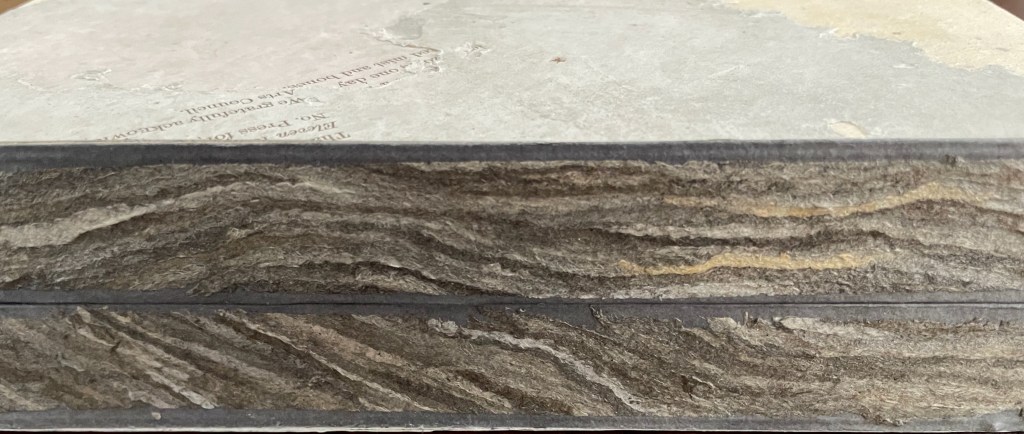 Close-up of the edge of a handmade book, showcasing textured paper and unique layering.