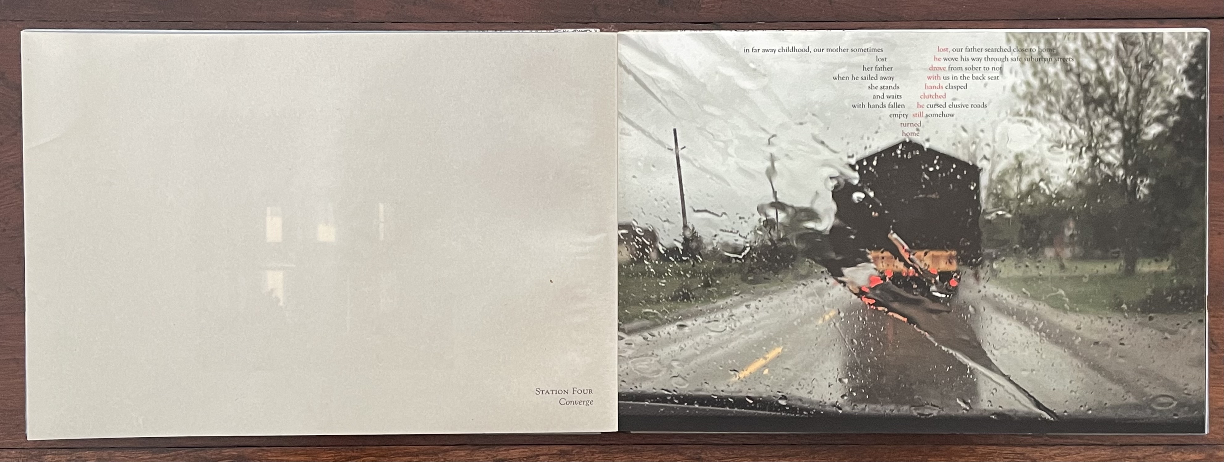 A handbound artist's book titled 'Station Four: Converge' by Marlene MacCallum, featuring a visually striking layout with text and imagery. The left side shows a plain cover with the title, while the right side displays a digitally printed image of a rainy road scene, blurred by water droplets on glass. The text is poetically arranged over the image, exploring themes of memory and familial relationships.