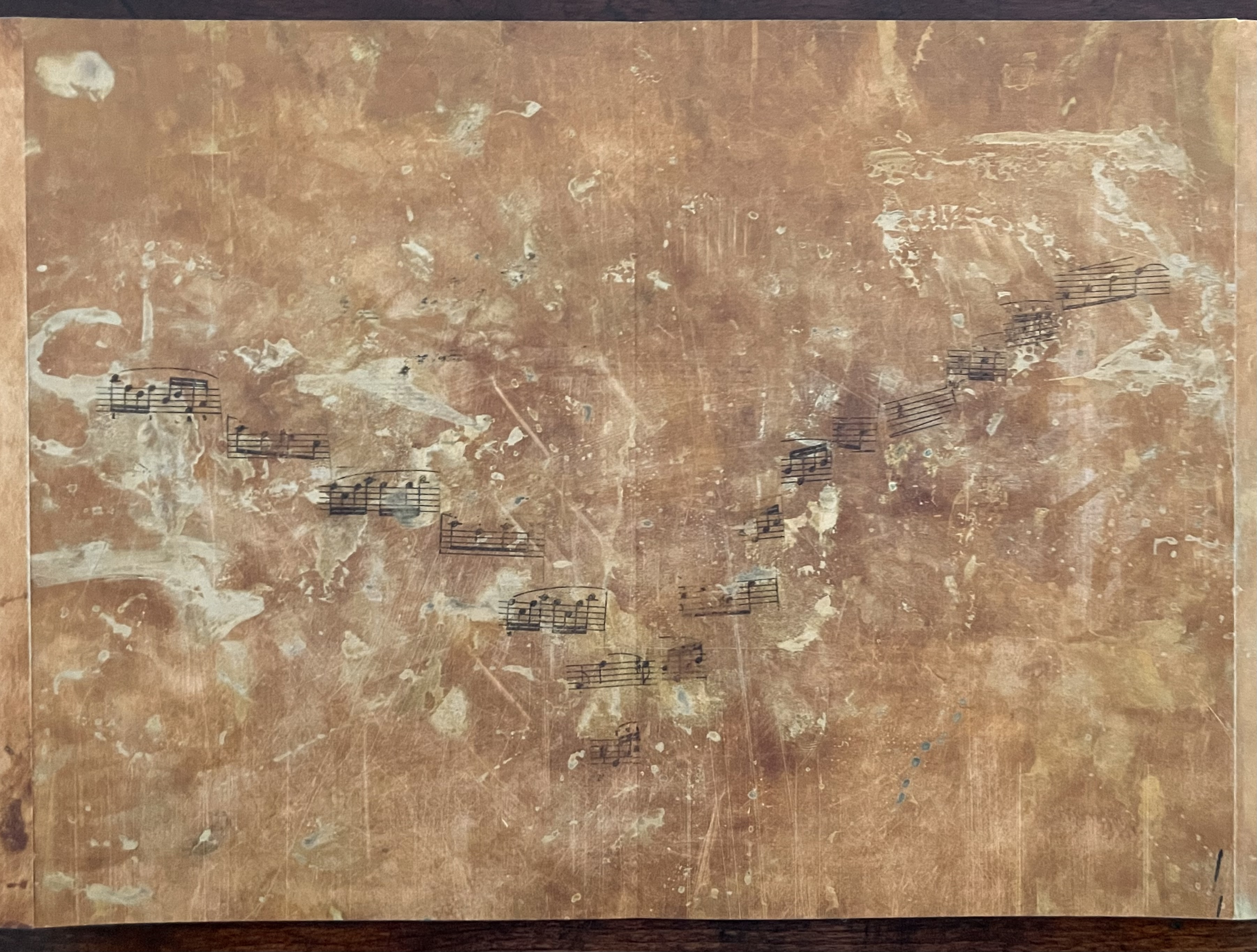 A textured surface featuring a faded image of musical notes against a warm, earthy background.