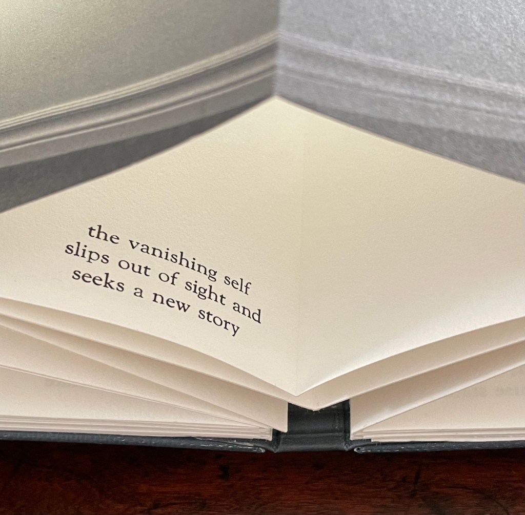 An open page of an artist's book featuring the text 'the vanishing self slips out of sight and seeks a new story' printed on a cream-colored background.