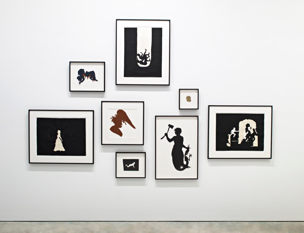 A collection of framed silhouette artworks displayed on a white wall, featuring various figures including a bride, a mermaid, and dynamic scenes in black and white.