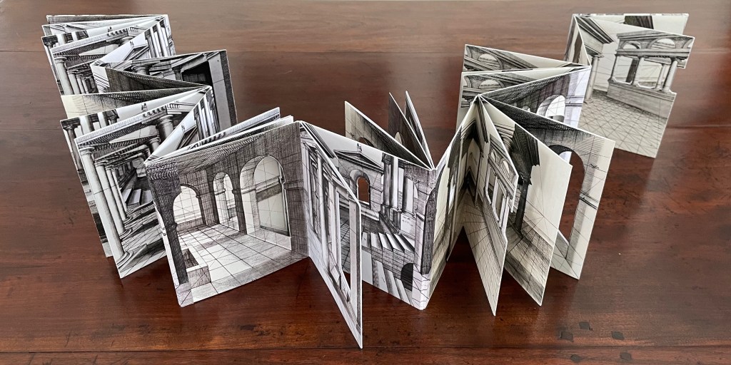 A handmade accordion-style book featuring intricate pen illustrations of architectural interiors, showcasing arches and tiled floors.