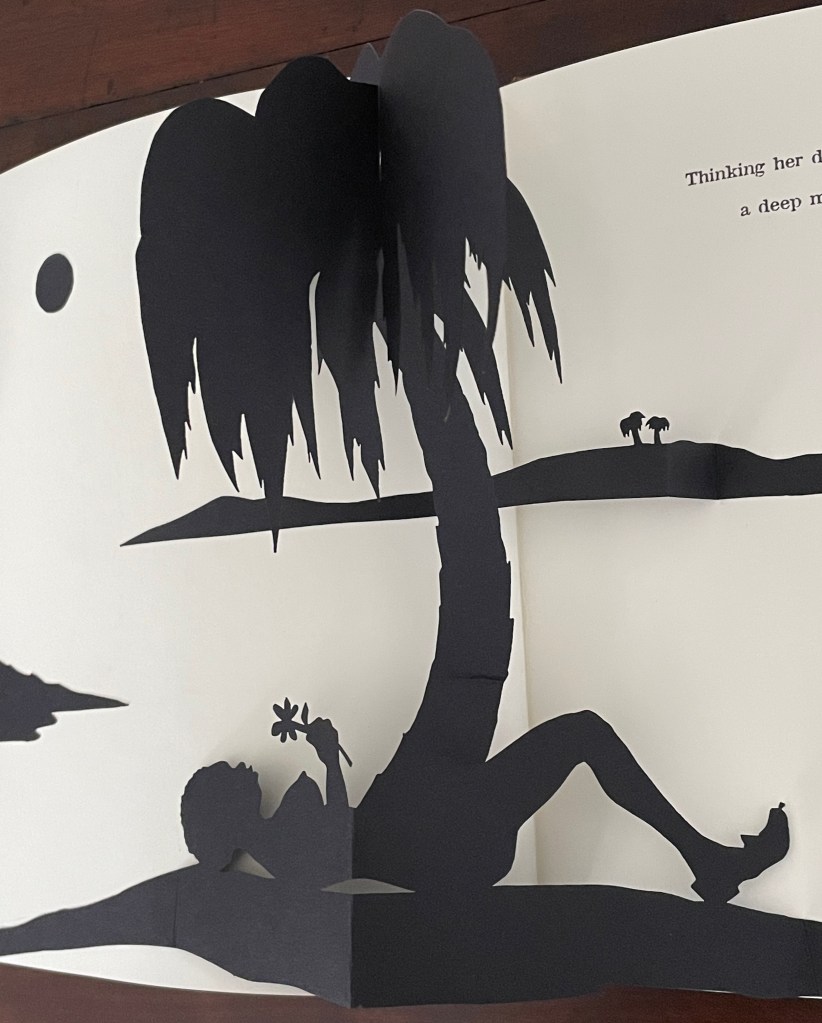 A paper cutout scene depicting a silhouetted figure lying beneath a palm tree, holding a flower, with a minimalist landscape featuring a sun and distant trees.