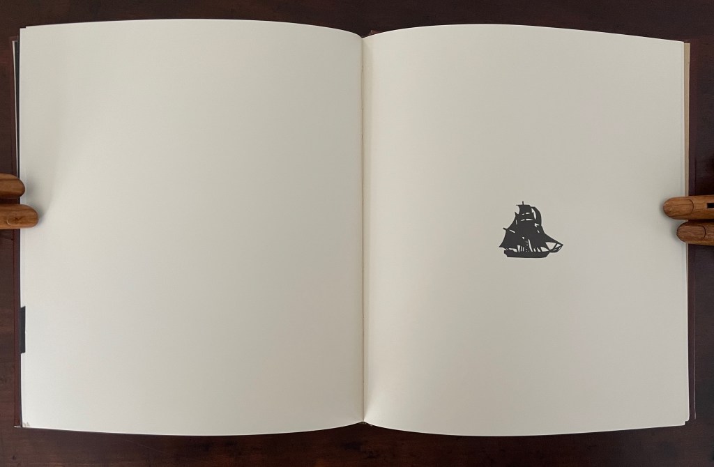 An open book with blank pages featuring a small silhouette of a ship in the center.