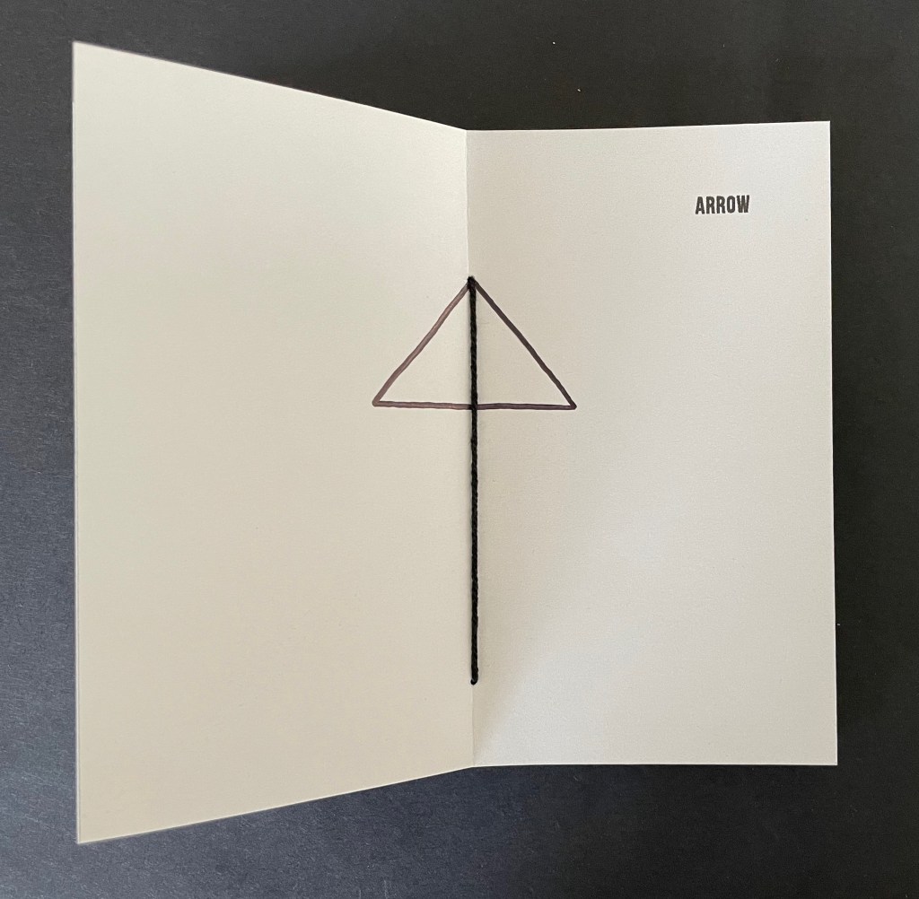 An open card with a simple drawing of a triangular arrow shape and the word 'ARROW' printed on the right side.