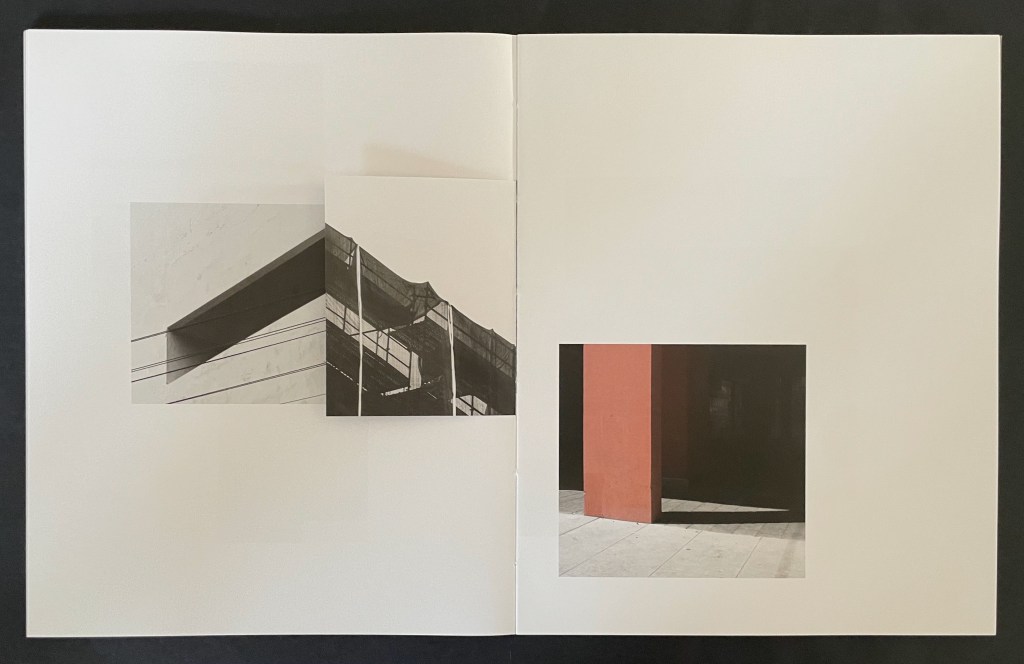 An open booklet showing two photographs, one featuring architectural elements in black and white with intersecting lines and textures, and another showcasing a red column against a dark background, both arranged on white pages.