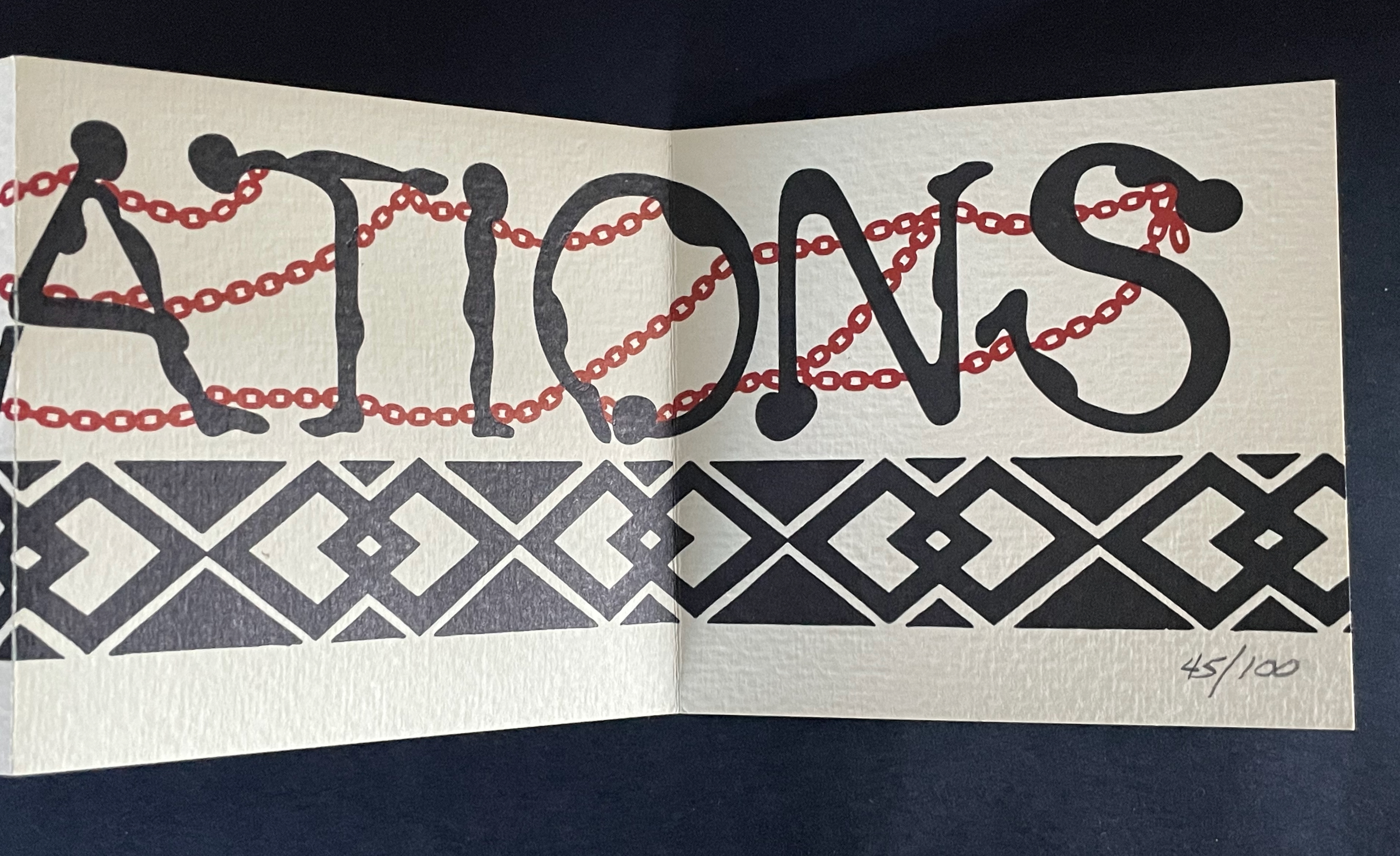 A close-up of an open book featuring stylized text spelling 'NATIONS' intertwined with red chains, above a decorative black and white pattern at the bottom. The page is numbered 45/100.