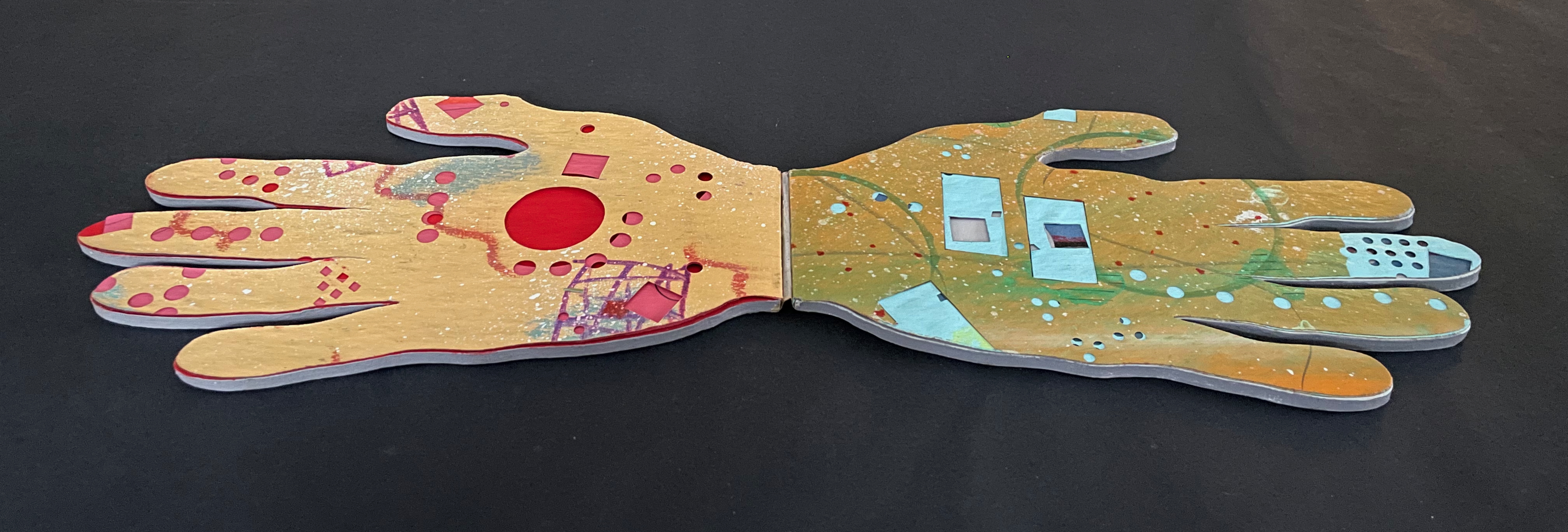 Artistic depiction of two open hands, one side painted with vibrant colors and patterns including red and blue shapes, and the other side featuring a contrasting design with geometric shapes and dots.