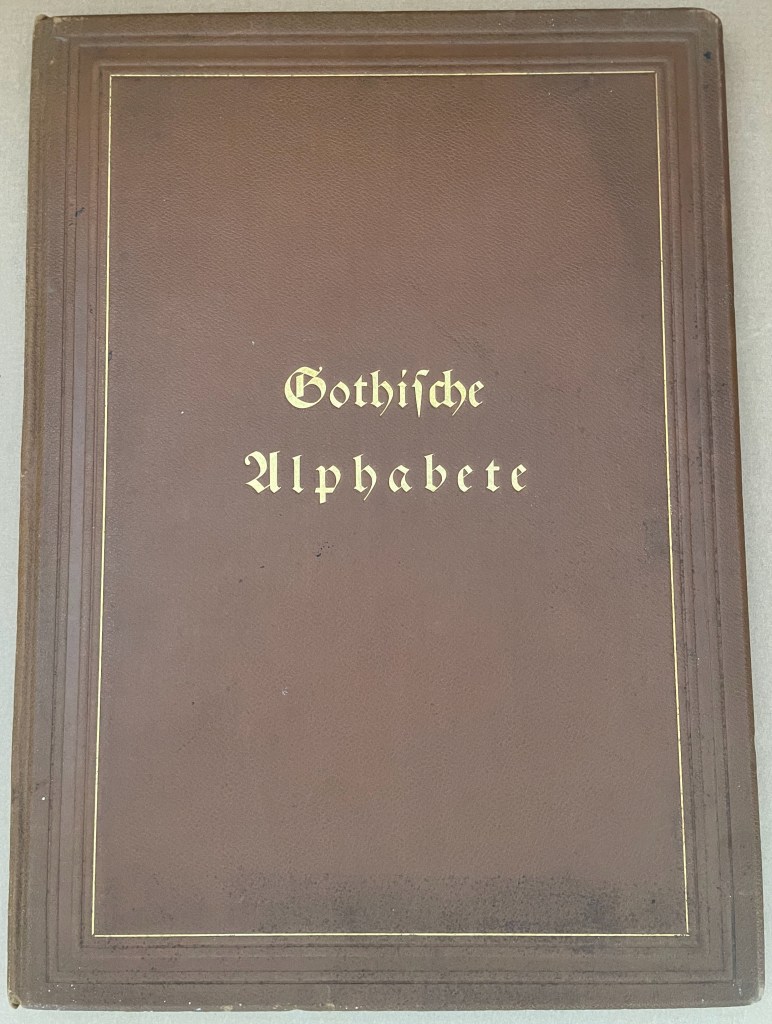A brown book cover titled 'Gothische Alphabete' in gold lettering.