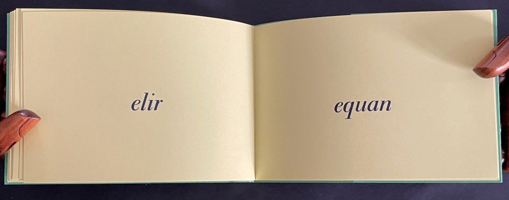 Opened book pages displaying the words 'elir' on the left page and 'equan' on the right page against a pale yellow background.