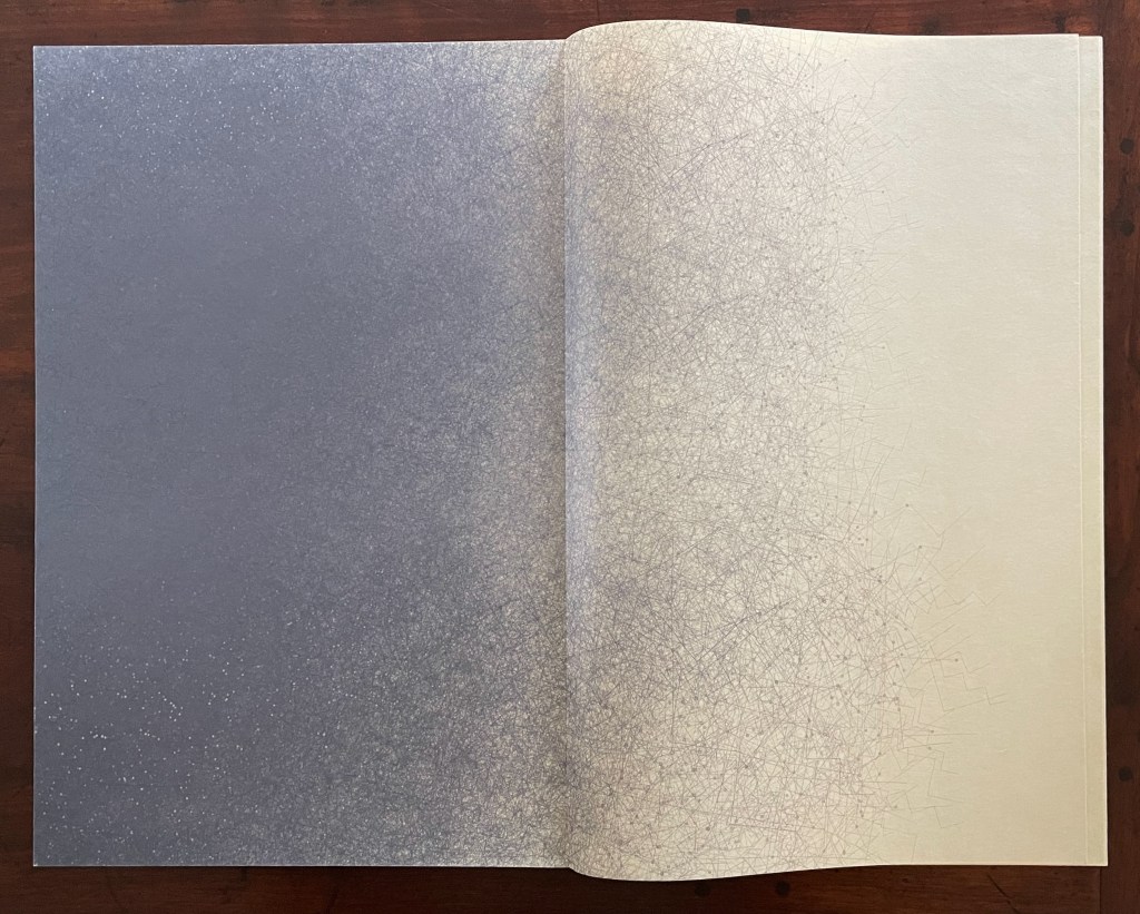 An open book with two pages showing a gradient design, transitioning from a dark gray to a lighter textured surface, with intricate patterns.