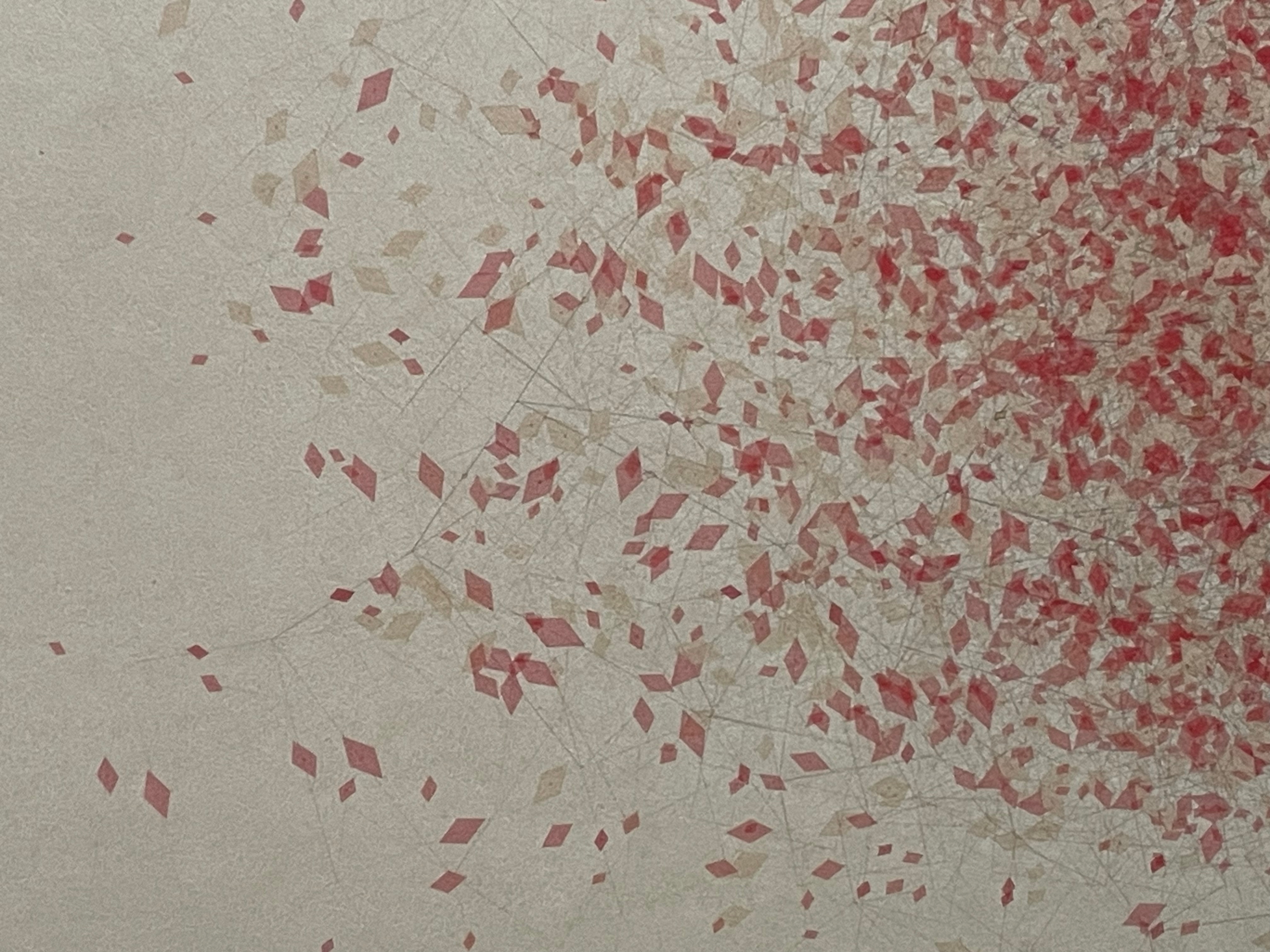 A textured abstract background featuring scattered shapes in shades of red and beige, creating a dynamic pattern against a light backdrop.