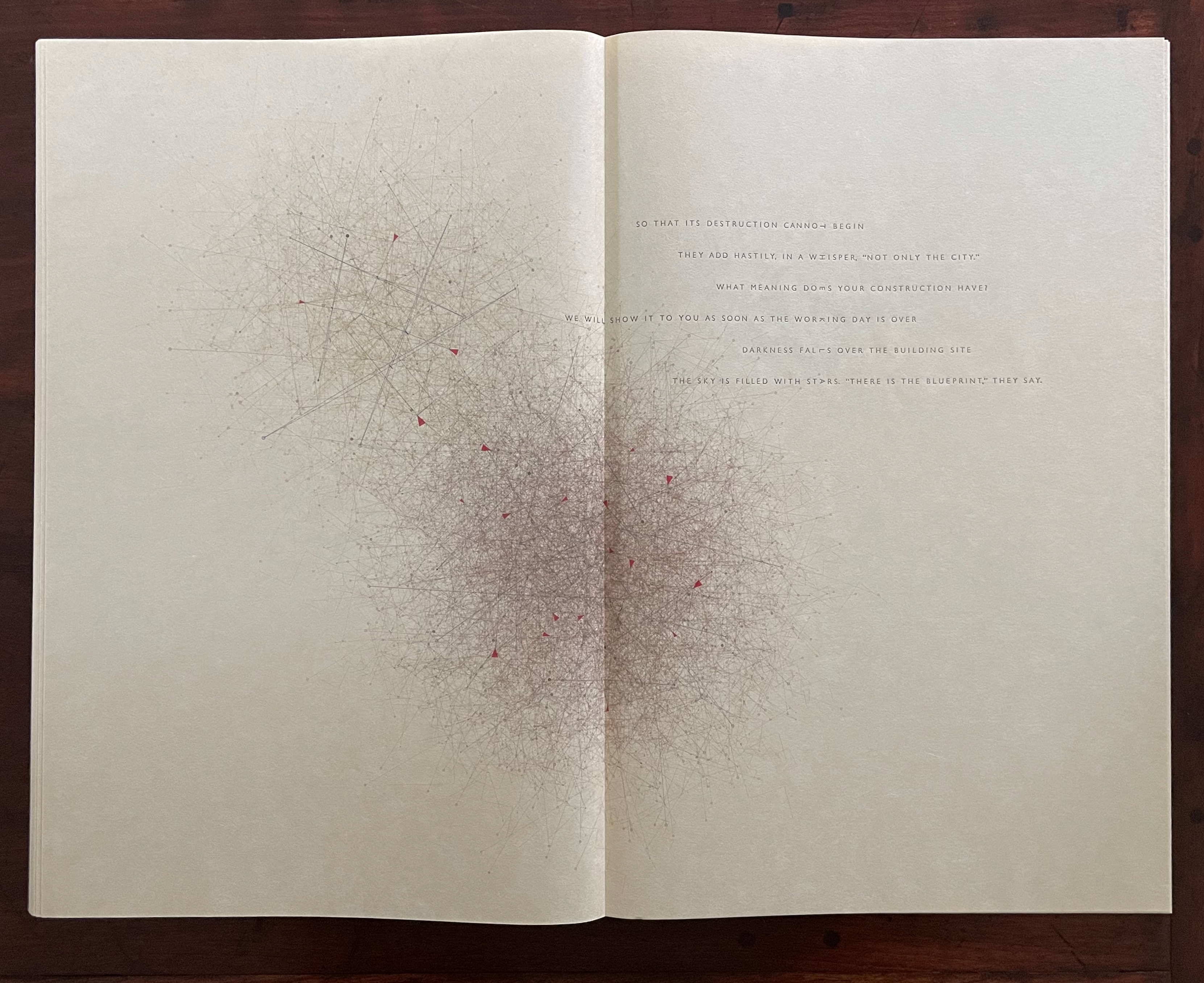 A spread of an open book featuring abstract line art and text. The left page displays a network of lines with red accents, and the right page contains poetic text related to construction and destruction.