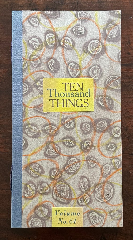 Cover of a booklet titled 'TEN Thousand THINGS', Volume No. 64, featuring abstract circular patterns and a blue spine.