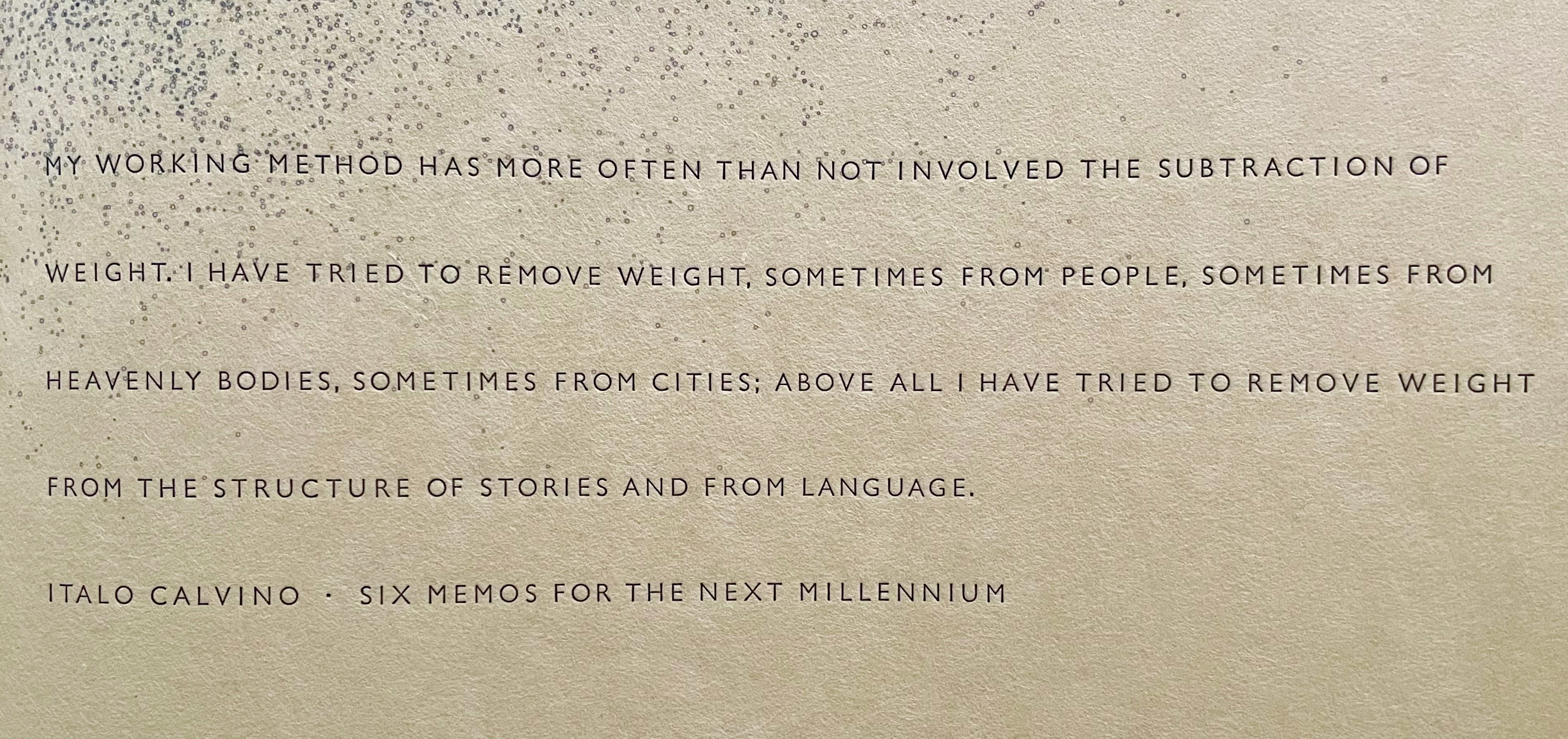 A close-up of a textured page with a quote by Italo Calvino discussing the removal of weight in various contexts, including people, cities, and language.