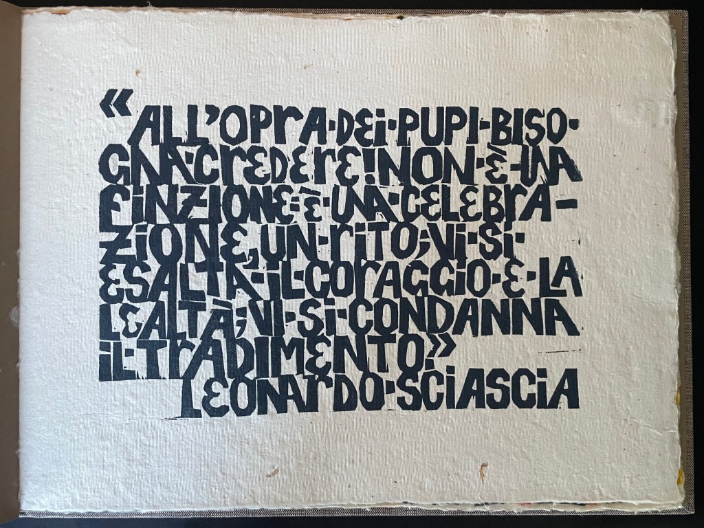 An artistic page featuring a quote in bold, stylized black typography on textured off-white paper.