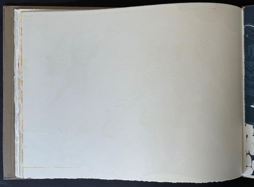 An open book page with a blank white sheet, showing the textured paper and slightly visible edges of previous pages.