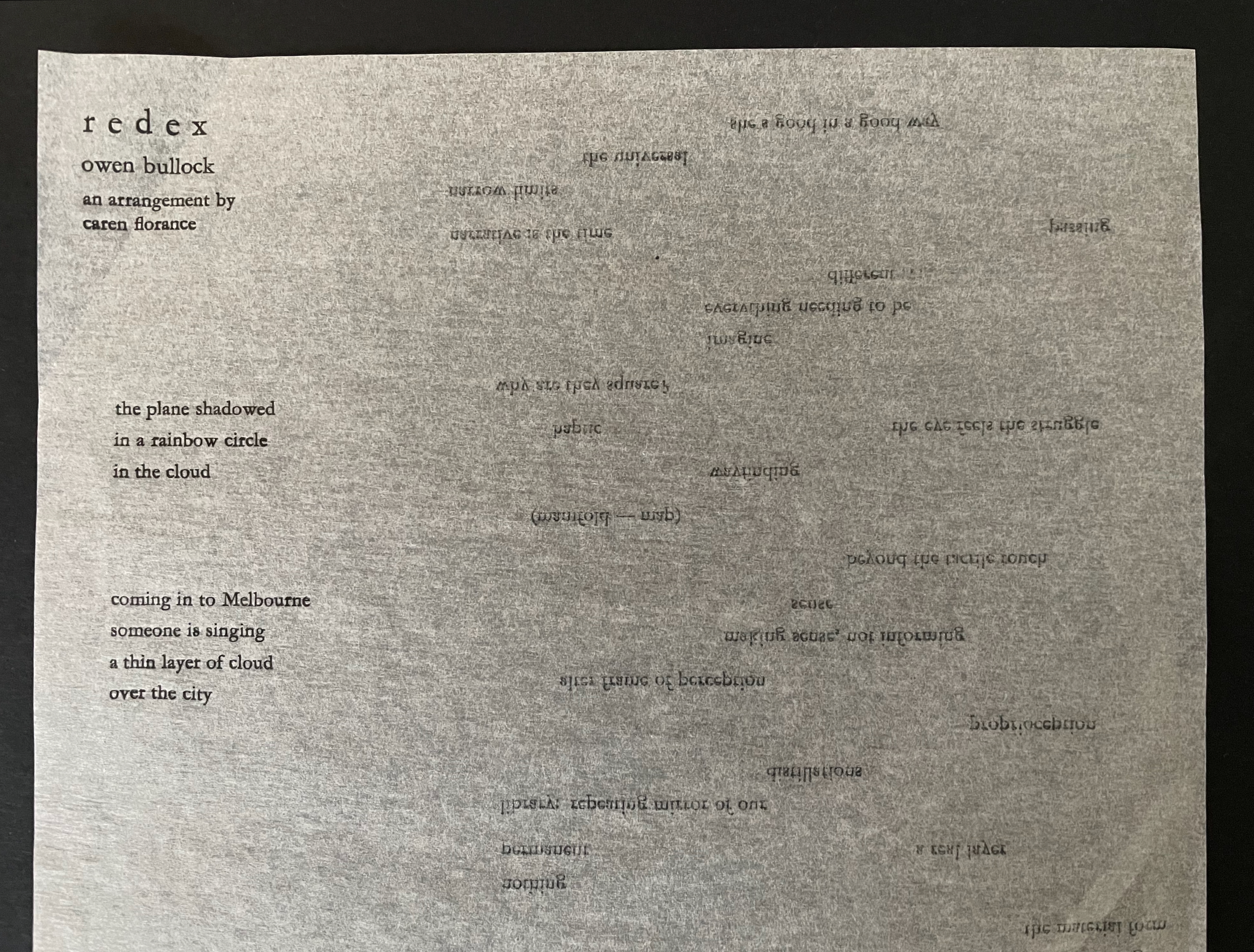 A page of printed text featuring a poem titled 'redex' by Owen Bullock, arranged by Caren Florance. The text appears creatively formatted, with elements like varying alignments and an abstract layout, set against a gray background.