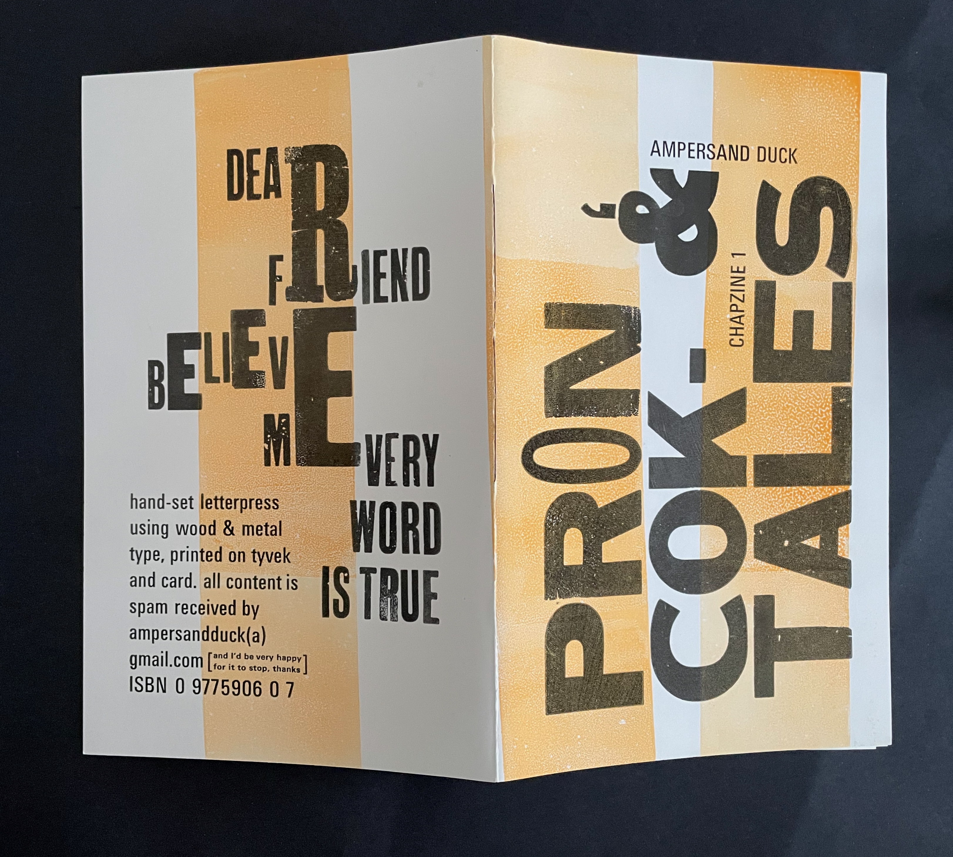 A folded chapbook titled 'Ampersand Duck - Chapzine 1' featuring a hand-set letterpress design. The cover includes bold, artistic lettering and a color scheme of white, orange, and black. It highlights phrases like 'Dear Friend, Believe Me, Every Word is True' along with details about the printing method and contact information.