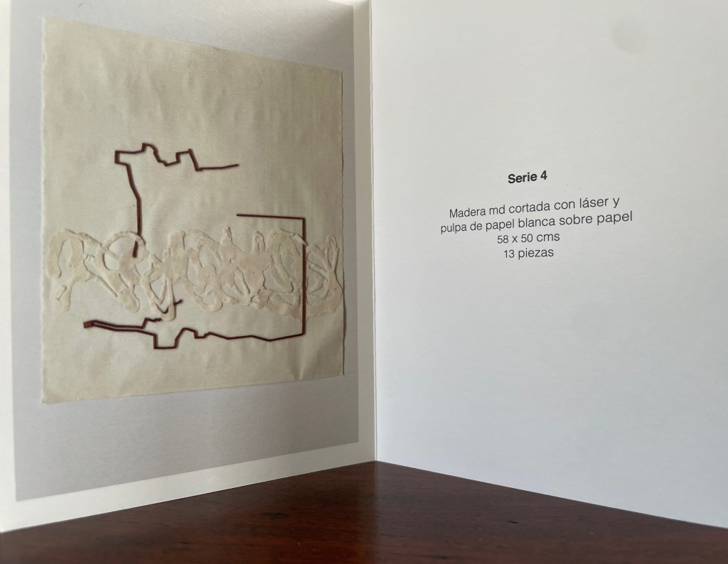 An art piece showcasing laser-cut wood and white paper pulp on paper, displayed in a booklet. The dimensions are 58 x 50 cm and it is part of a series with 13 pieces.