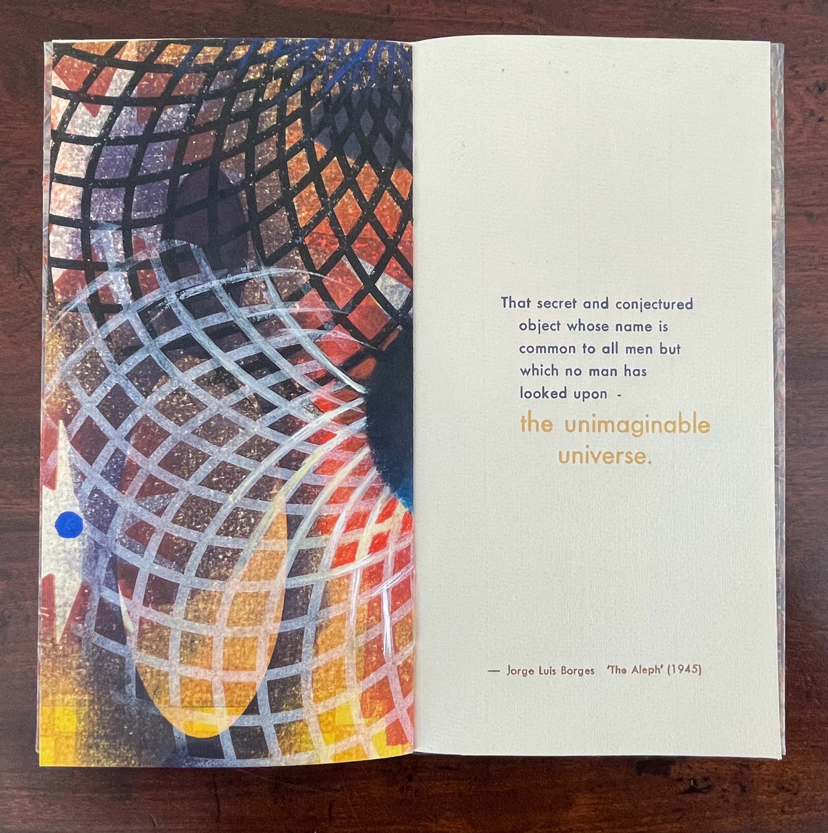 An open book page featuring colorful abstract art with a grid pattern on the left side and a quote by Jorge Luis Borges about 'the unimaginable universe' on the right.
