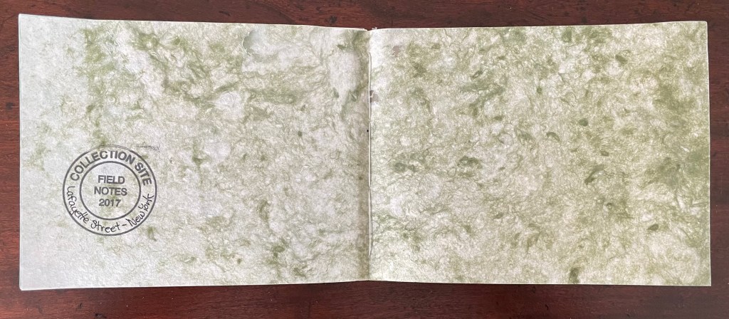 An open field notes notebook with a green marbled cover, stamped with 'COLLECTION SITE' and 'FIELD NOTES 2017' on the left page.