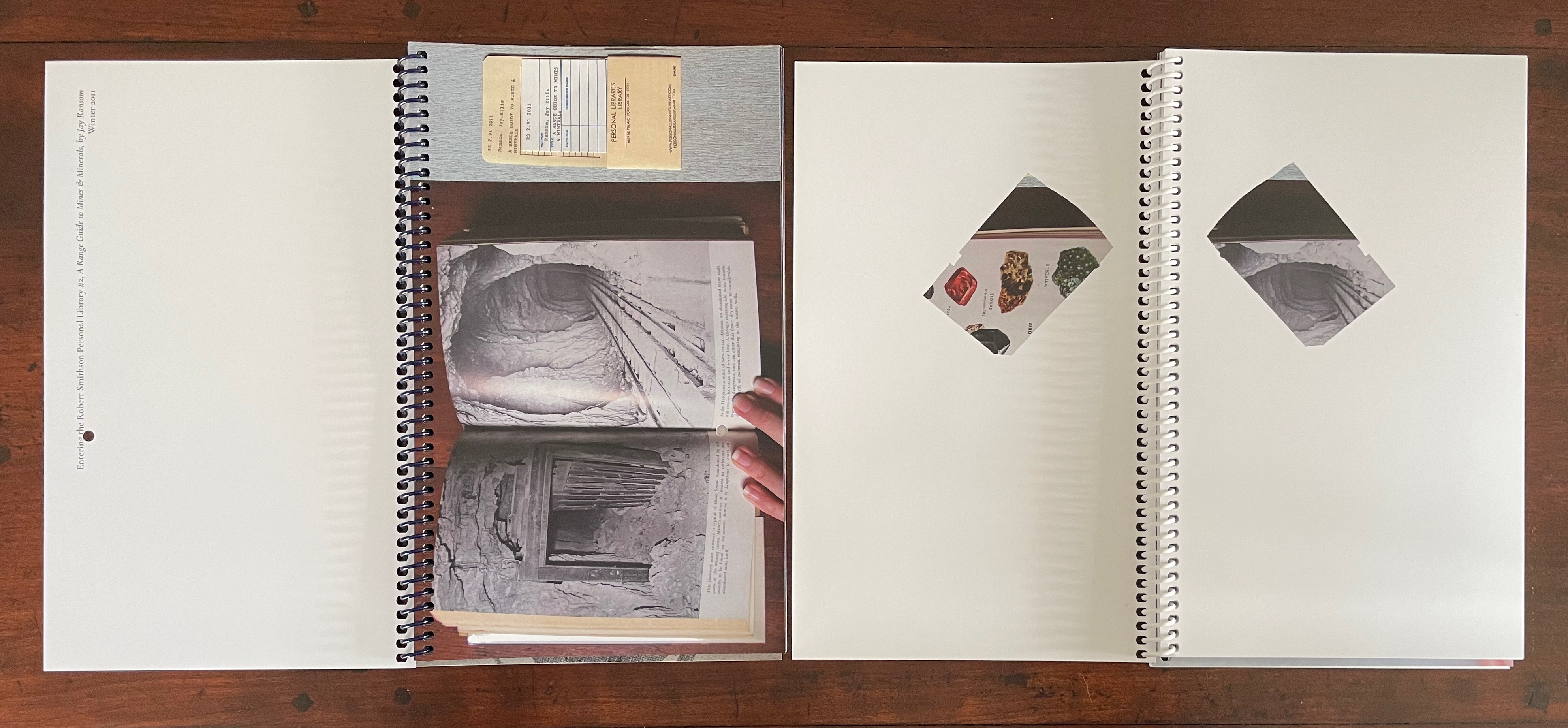 An open spiral-bound book displaying a page with a black and white image of a tunnel, alongside a hand pointing towards the image.