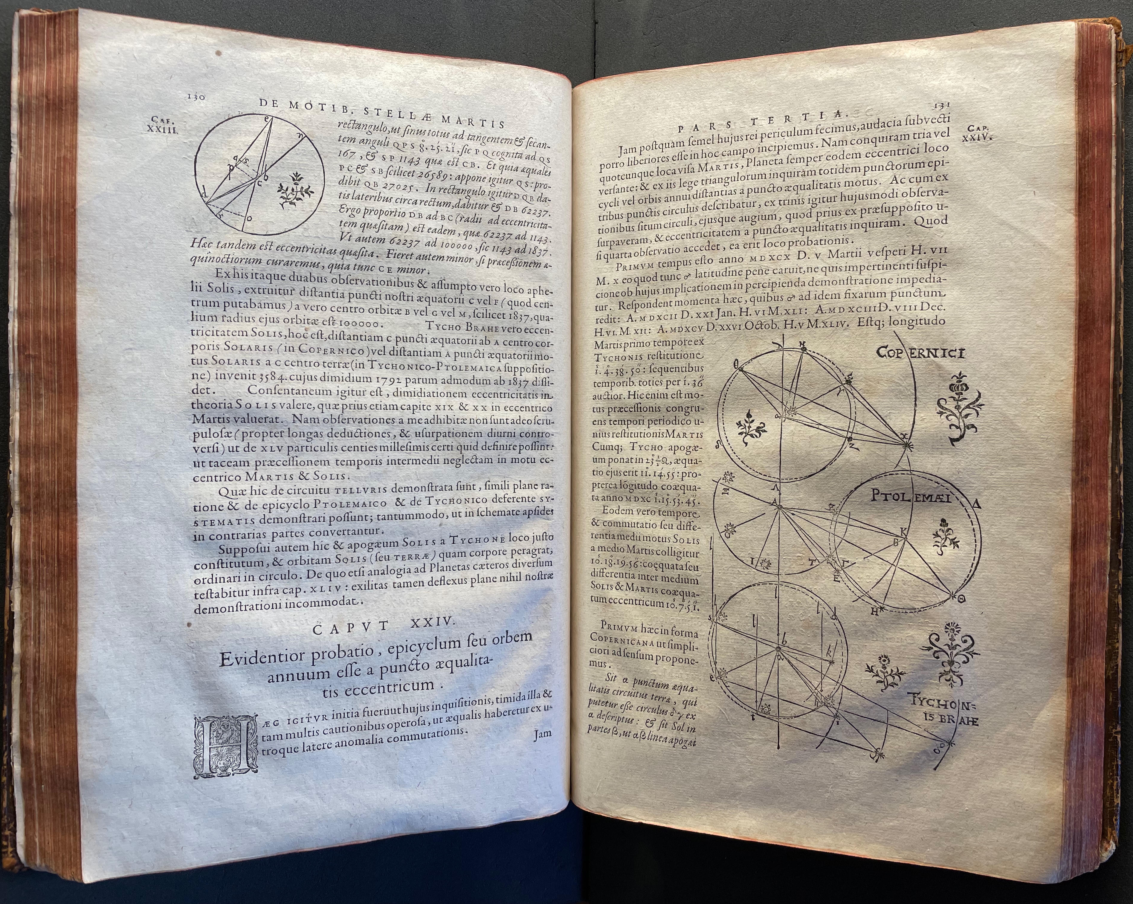 An open historical astronomy book page displaying diagrams of circular orbits with annotations, including references to Copernicus, Ptolemy, and Tycho Brahe.