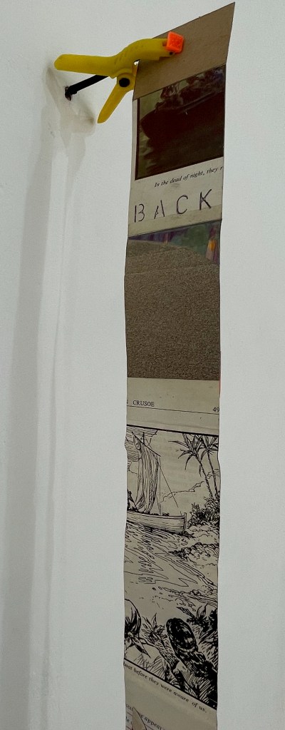 A vertical collage of images and text attached to a wall with a yellow clamp, featuring a photograph of a boat, handwritten text that reads 'BACK,' and illustrations of a ship and nature.