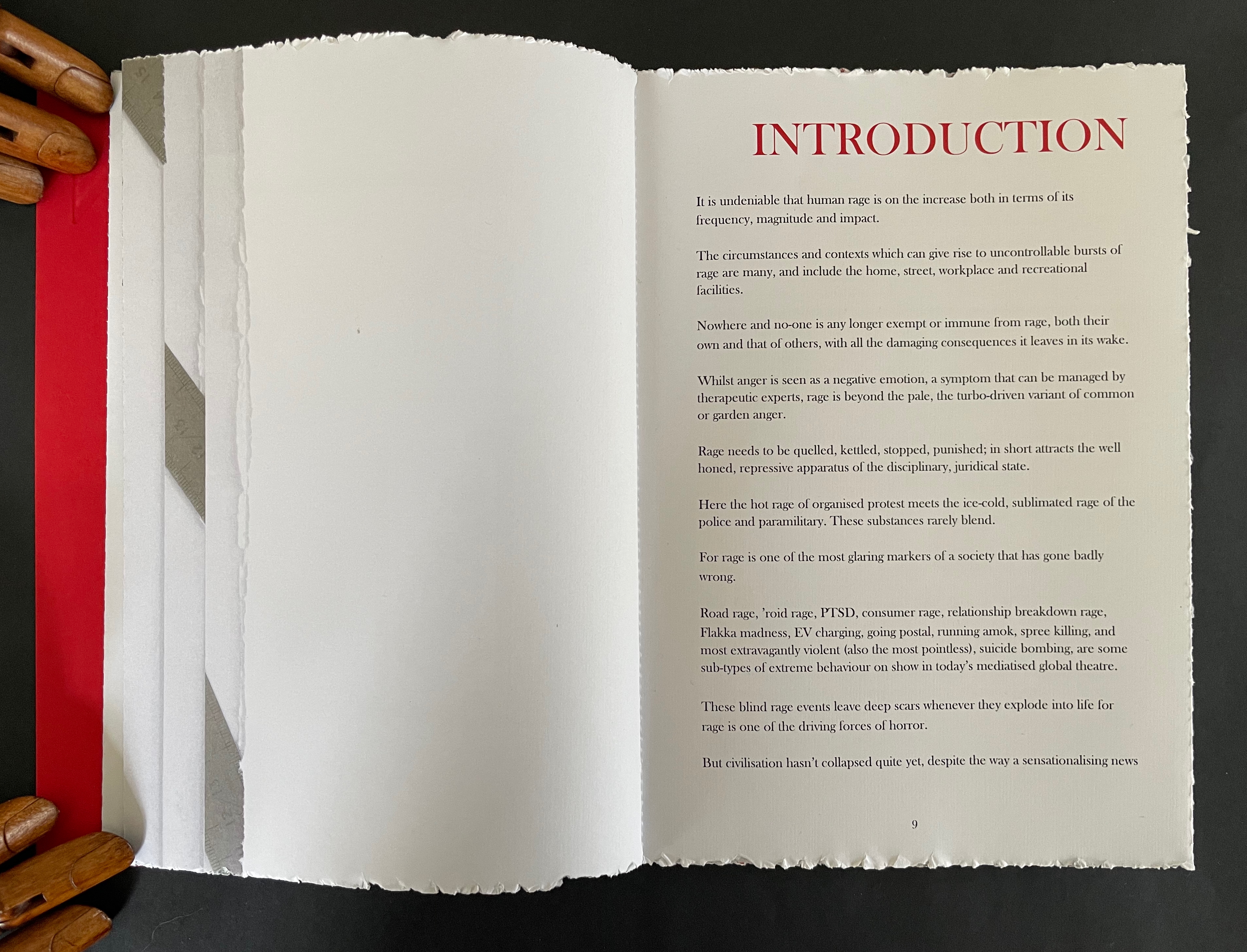 An open book page featuring an introduction section about human rage, with visible text discussing its implications, societal impact, and various forms. The page has a decorative edge and is next to a red and gray tabbed margin.