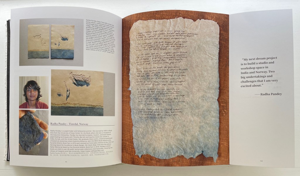 An open book featuring artwork and text by Radha Pandey, showcasing two pieces of textured paper art arranged on the left page, along with images of the artist and her work. The right page includes a quote from Radha Pandey about her future projects.