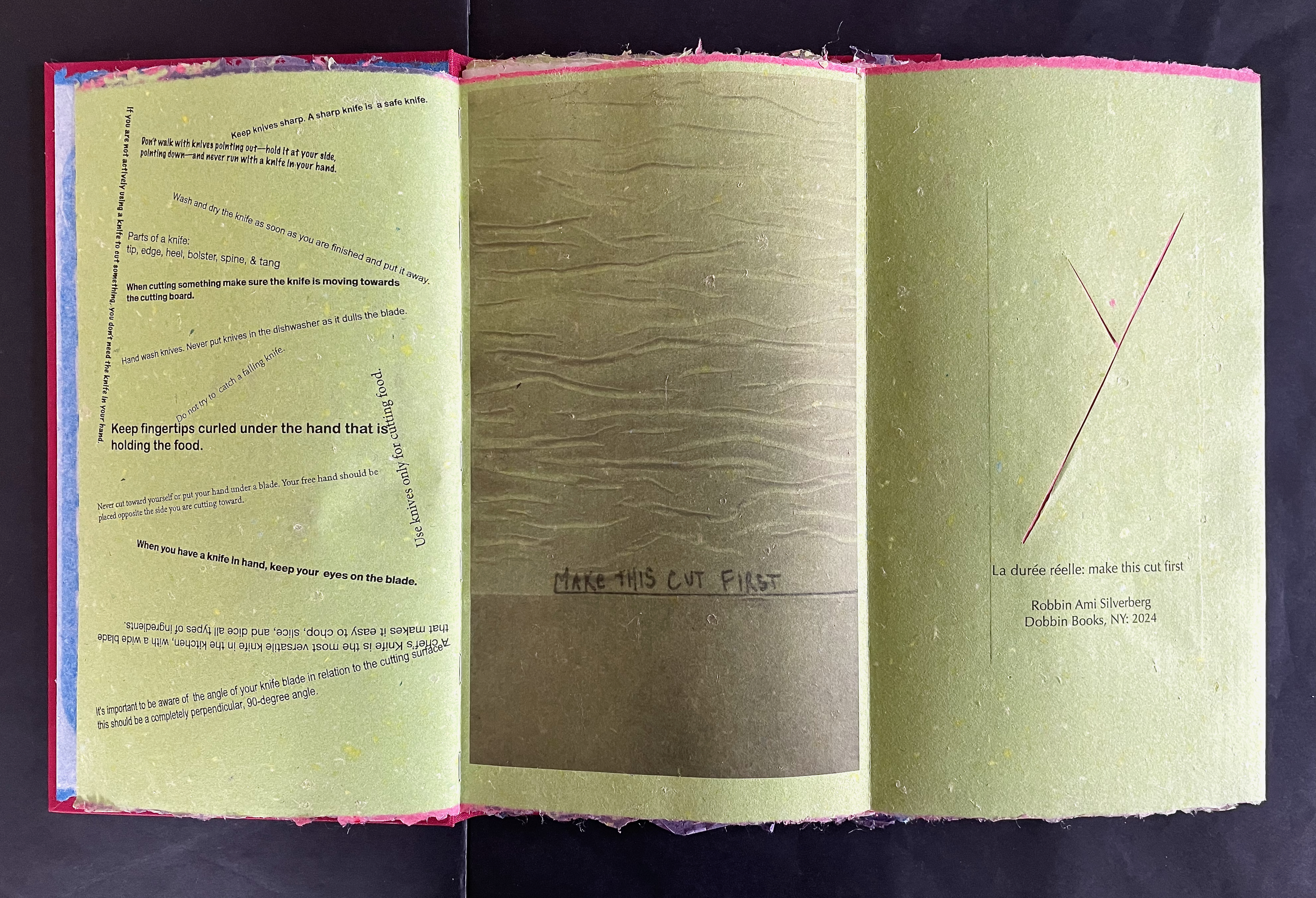 An open book with brightly colored pages displaying safety instructions for using a knife, interspersed with illustrated cut lines. The left page features text on knife handling and safety tips, while the right page includes a marker note and a design element with cut lines.
