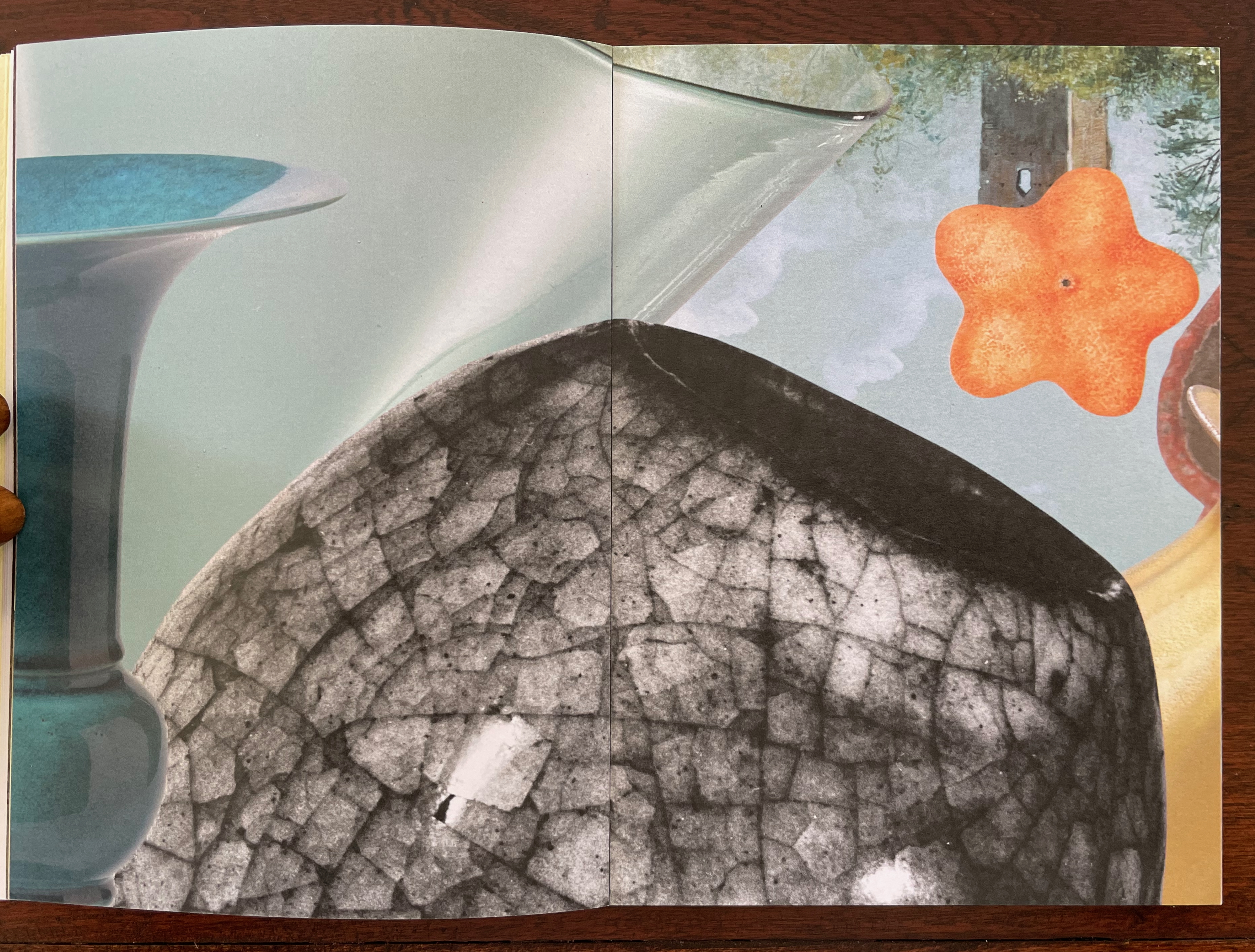 A collage featuring artistic elements including a blue glass vase, a textured black shape, and a bright orange star shape against a soft background.