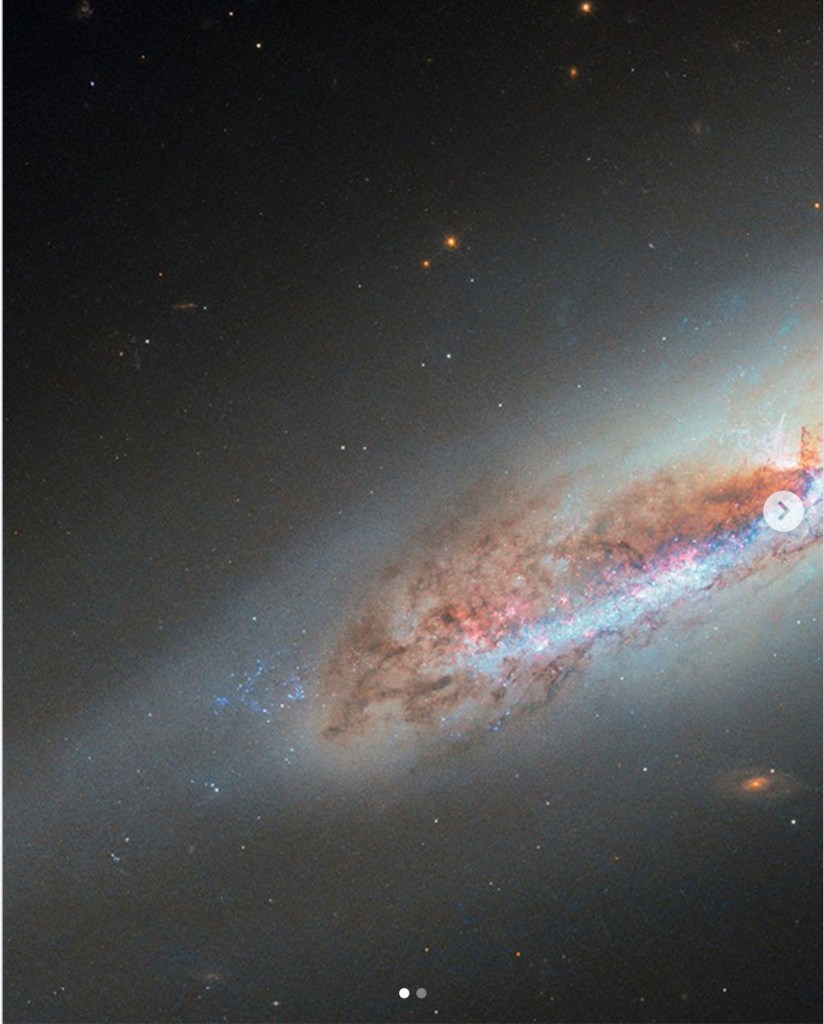 A vibrant image of a galaxy showcasing swirling clouds of stars and cosmic dust against a dark background.