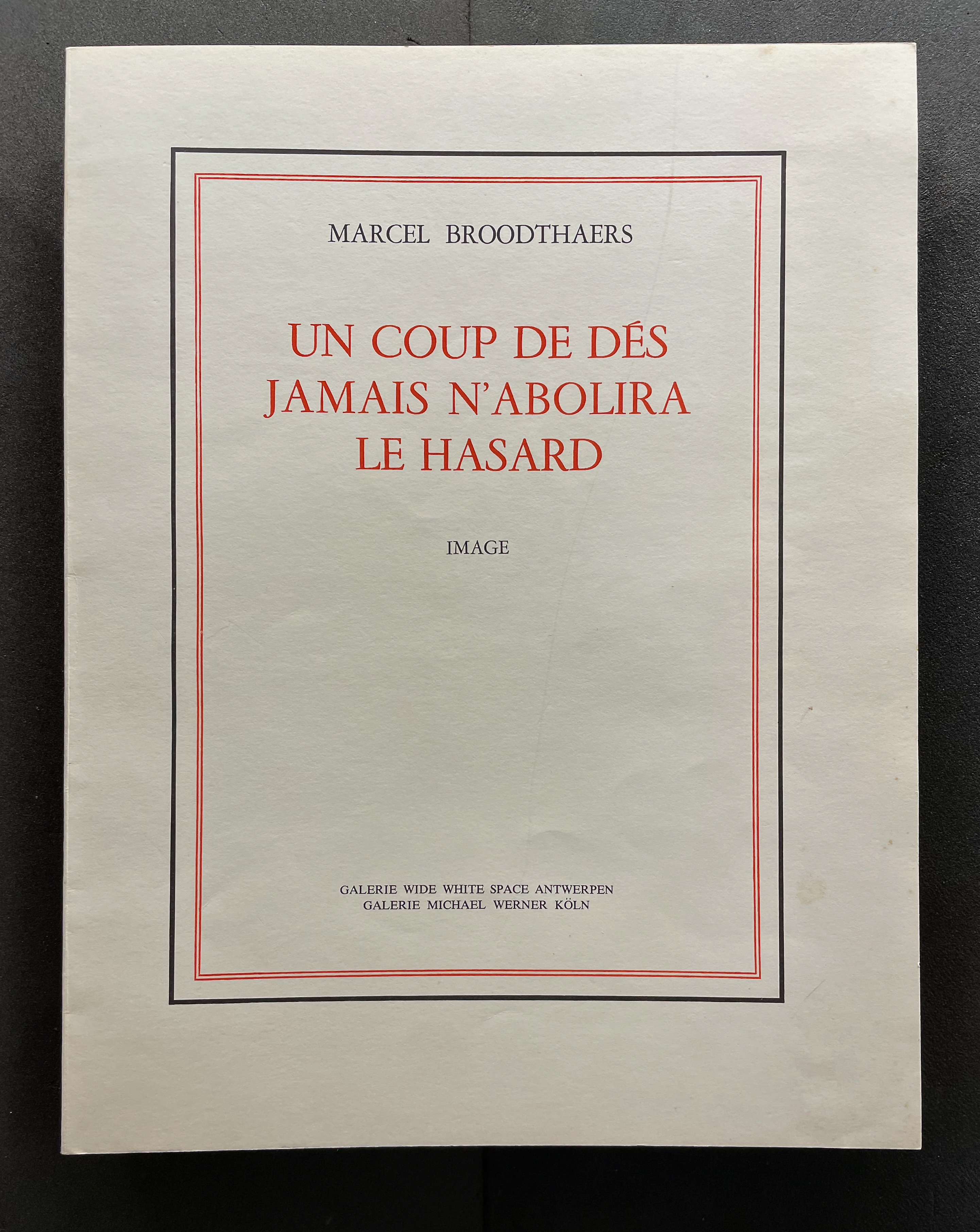 Cover of a publication by Marcel Broodthaers titled 'Un Coup de Dés Jamais N'abolira Le Hasard', featuring bold red text and decorative borders.