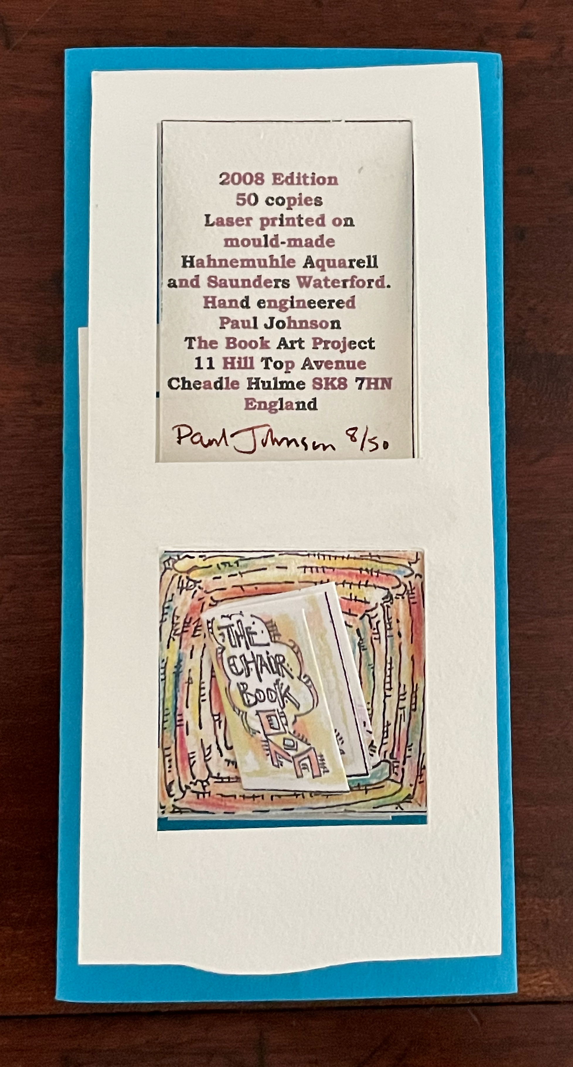 A certificate of authenticity for a 2008 limited edition book titled 'The Chair Book,' hand-engineered by Paul Johnson. It is signed and numbered 8/50, featuring details about its printing and publication.