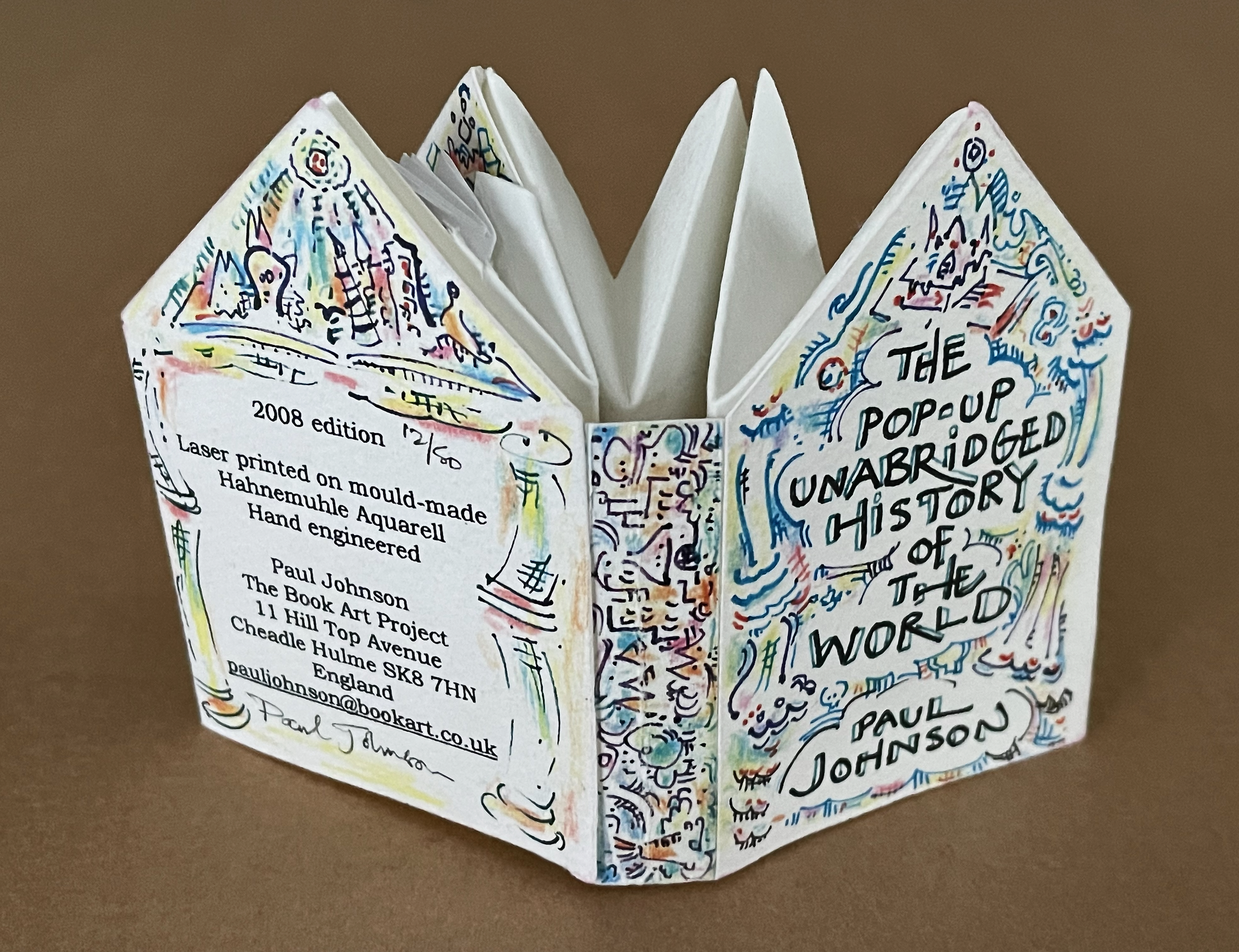 A colorful pop-up book titled 'The Pop-up Unabridged History of the World' by Paul Johnson, displaying a unique design and text on its cover, with details about its 2008 edition and production.