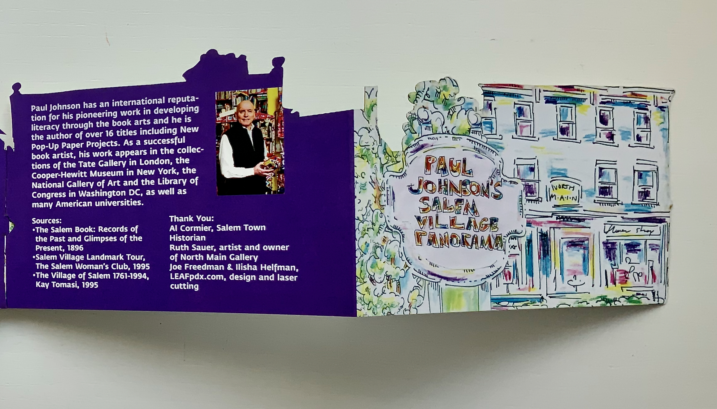Informational brochure about Paul Johnson, highlighting his work in book arts and literacy, featuring an illustration of 'Paul Johnson's Salem Village Panorama' and a photo of him holding books.