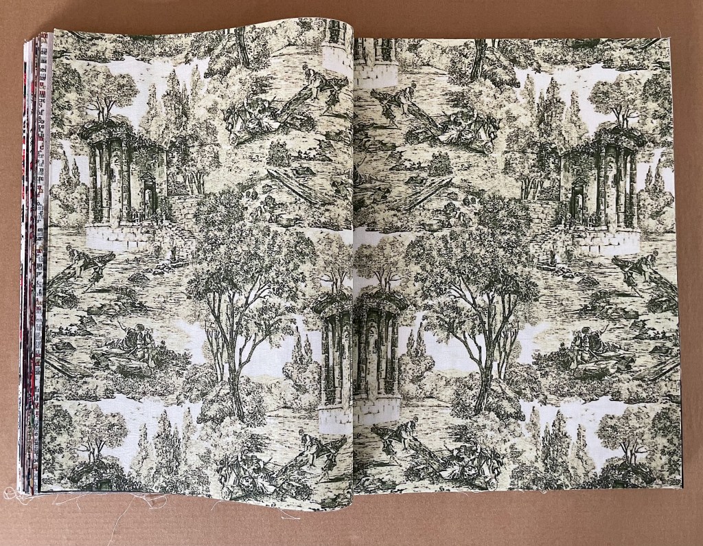 Open book displaying detailed vintage-style black and white illustrations of landscapes, ruins, and figures amidst trees.