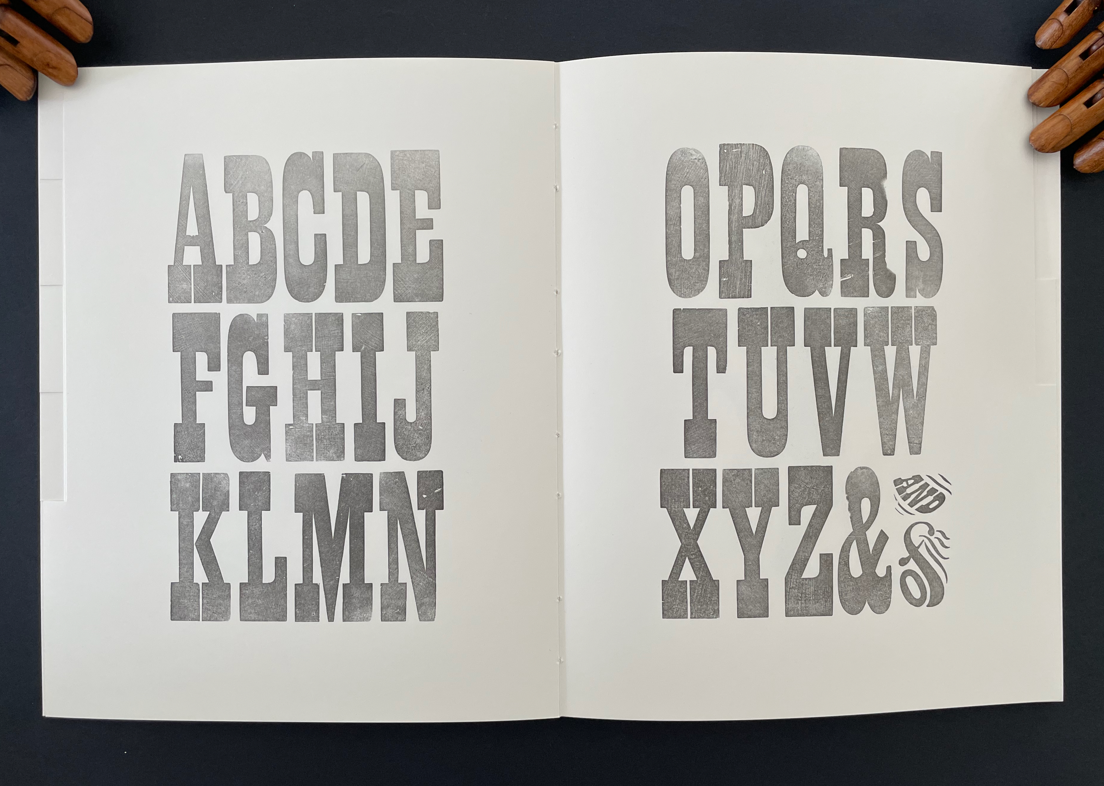 Illustration of the uppercase English alphabet displayed in two columns on a page, with letters A to M on the left and N to Z on the right, featuring a vintage font style.