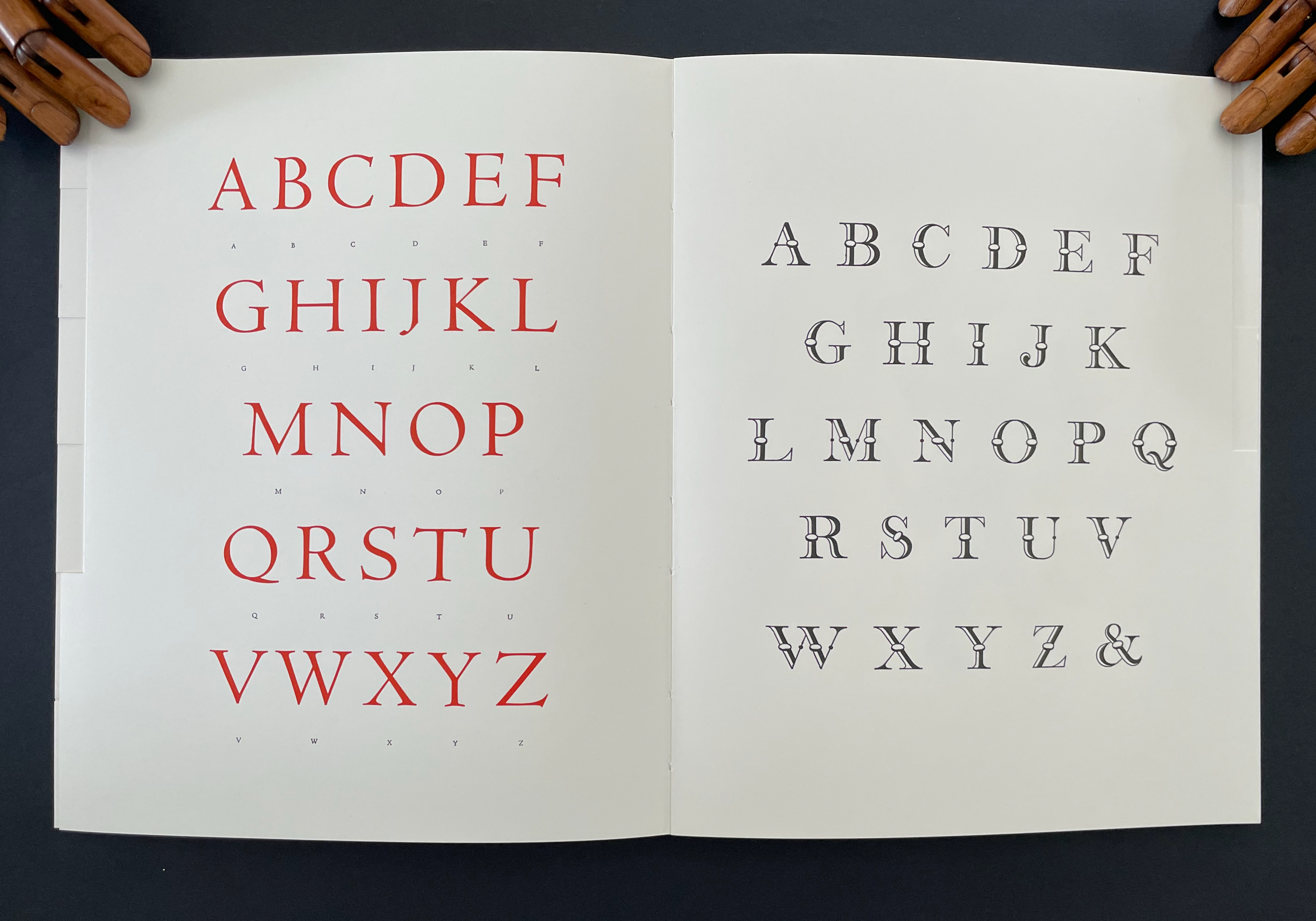 Open book displaying two pages of the alphabet in red and black, showcasing uppercase letters A to Z.