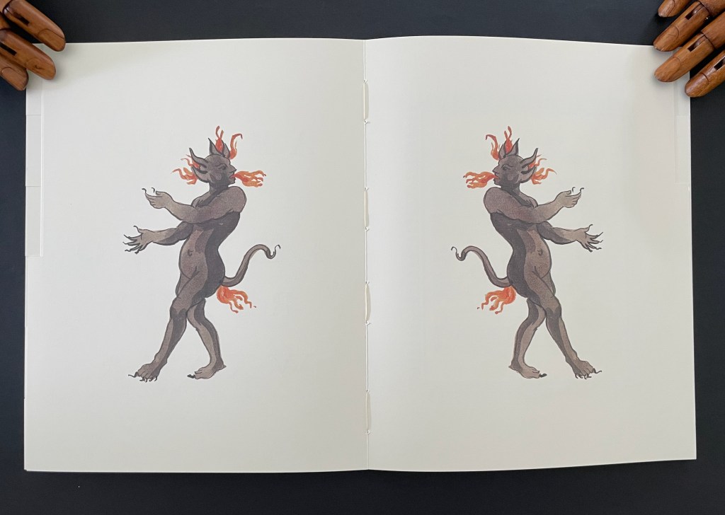 Illustration of a mythical figure with horns and flames on its head, posed with outstretched arms, printed on a two-page spread.