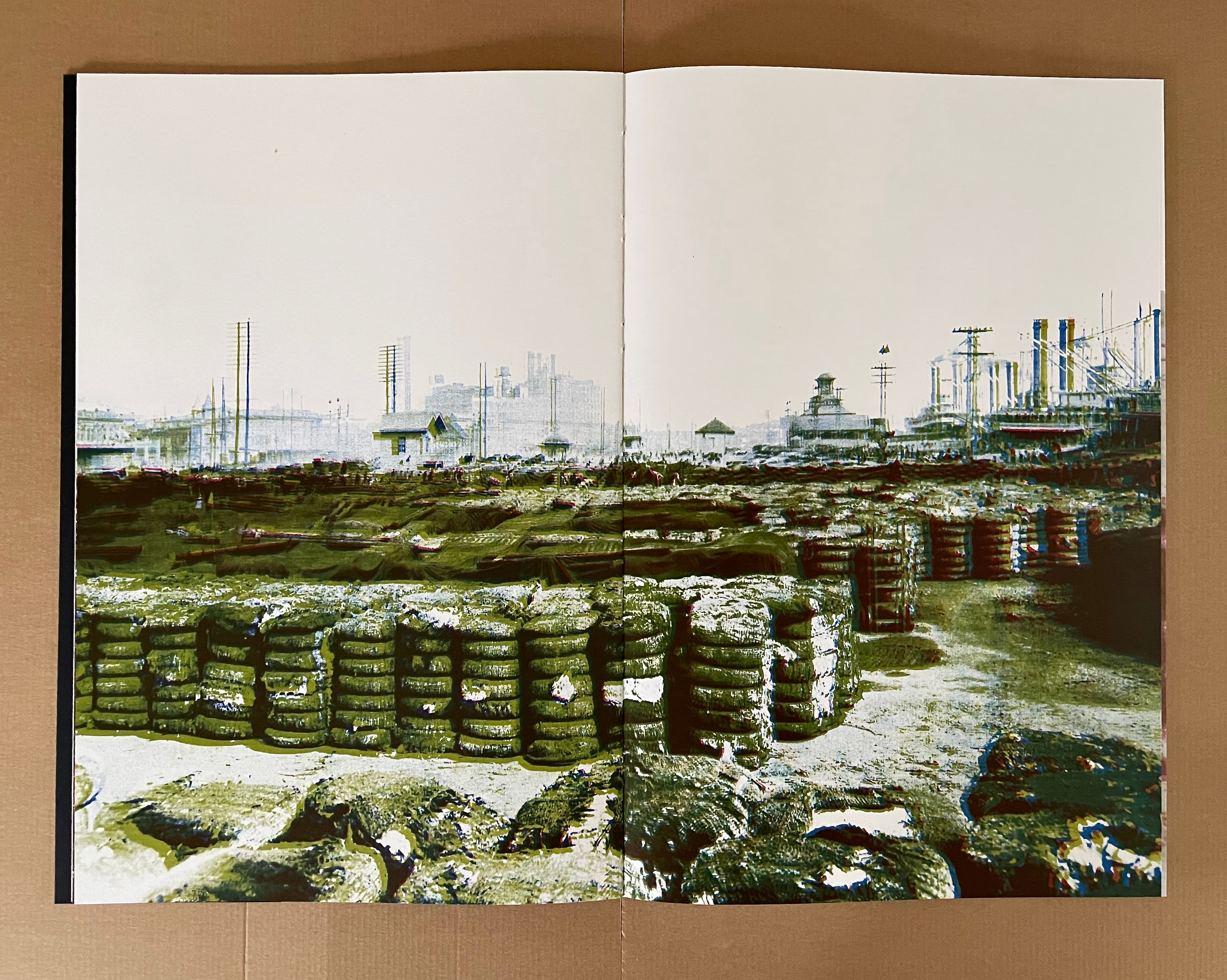 A vintage industrial landscape featuring stacks of tires and structures in the background, with a hazy atmosphere and muted colors.