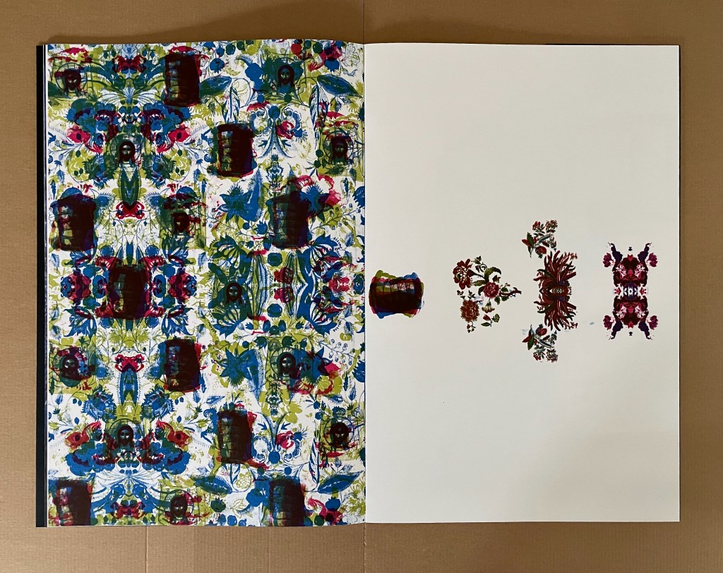 An open book page featuring a vibrant floral pattern in blue, green, and red on the left side, contrasting with a blank and simple white page on the right that displays a few decorative floral elements.