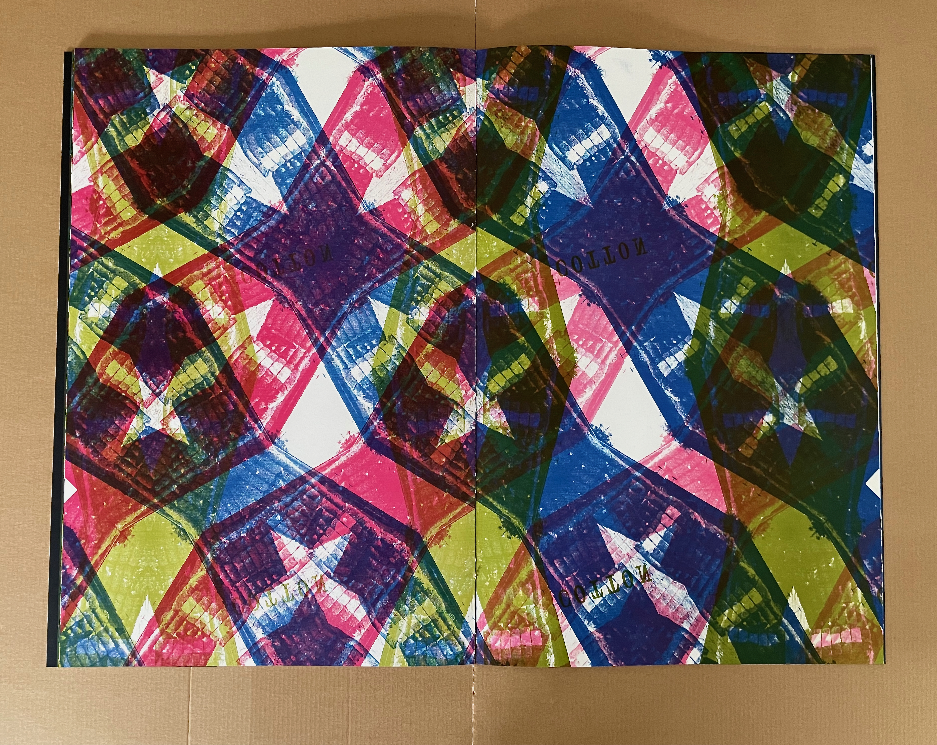 An open book with colorful abstract patterns featuring vibrant hues of red, blue, green, and pink, creating a kaleidoscopic effect.